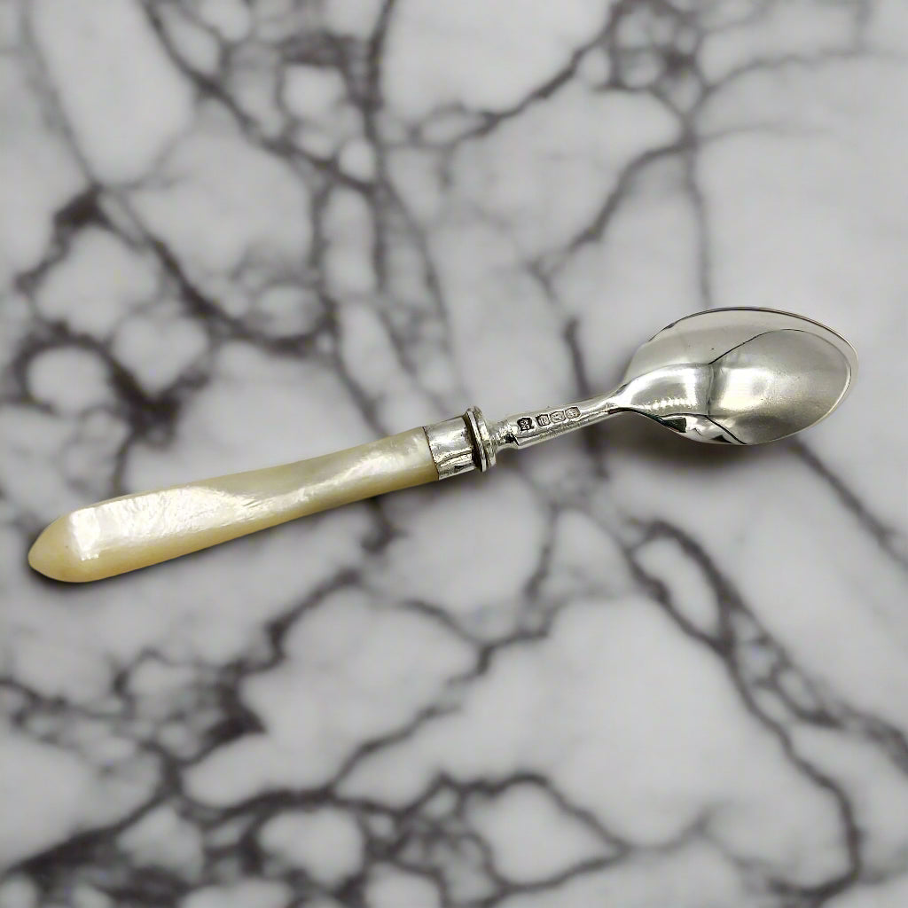 Spoon with a pearl handle on a marble background