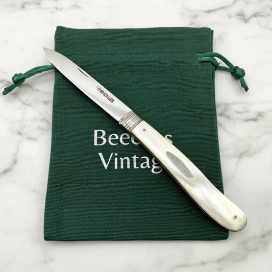 Large Antique Sterling Silver Fruit Knife on green bag and marble surface