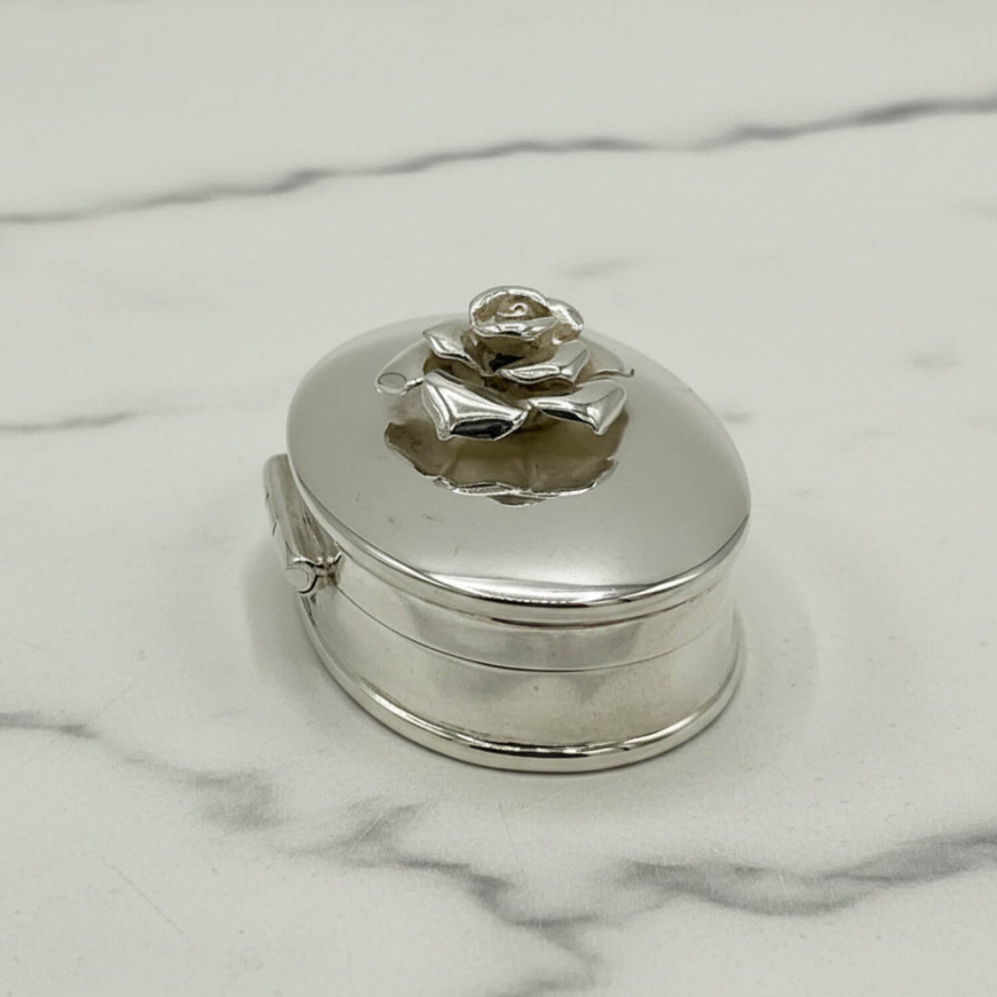 side view of Large Rose Sterling Silver Pill Box on a marble surface