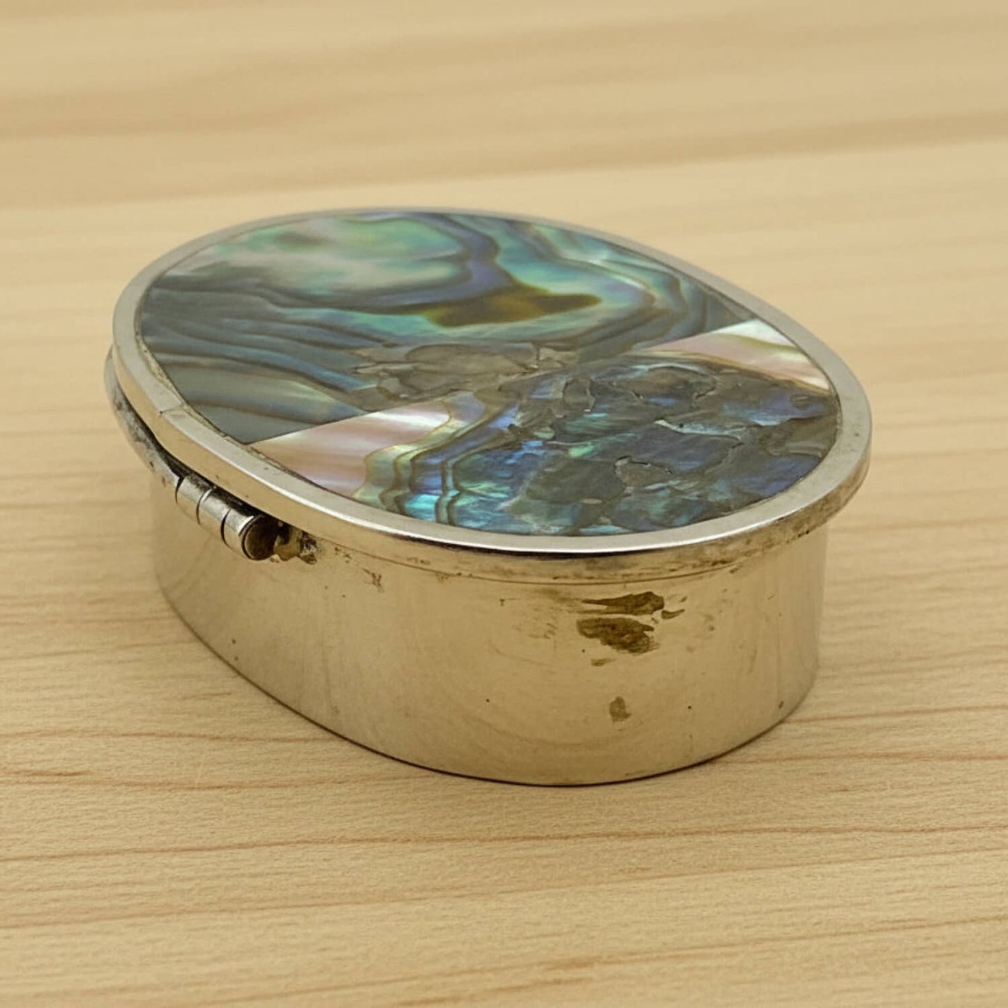 Side view of Mexican Abalone Shell Pill Box on wood table