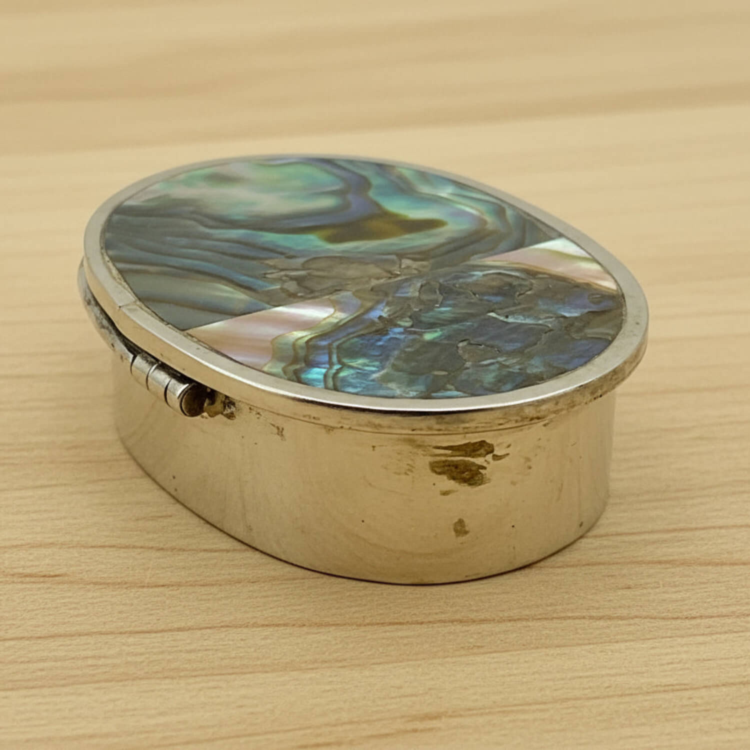 Side view of Mexican Abalone Shell Pill Box on wood table