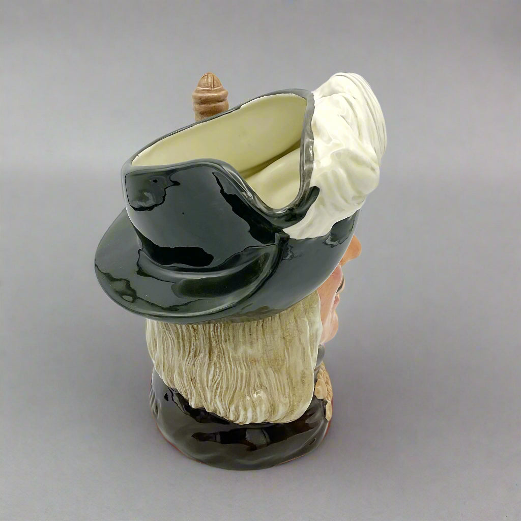 Side view of Large Aramis China collectible toby jug on plain background.