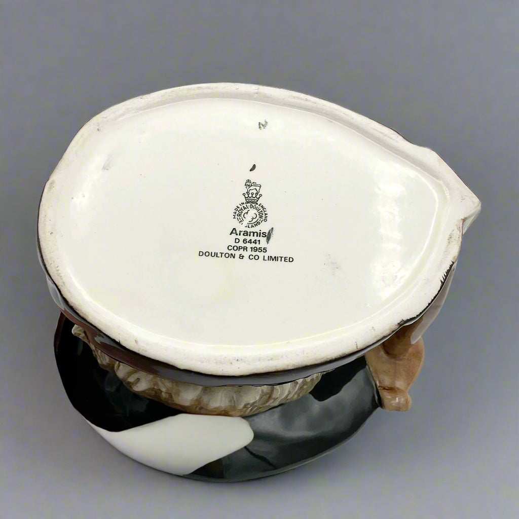 Base of Large Aramis toby jug on plain background.