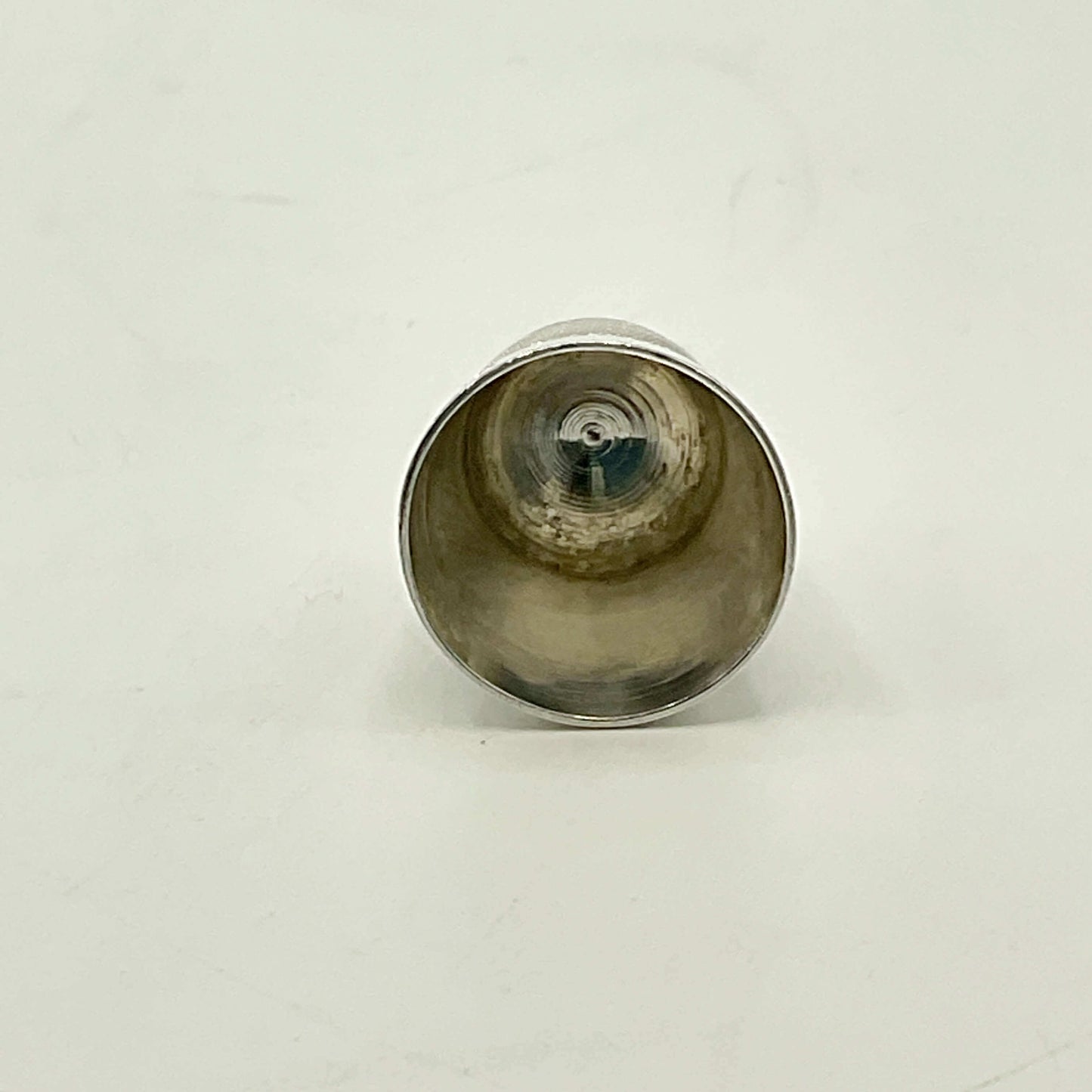 Silver thimble on a white background