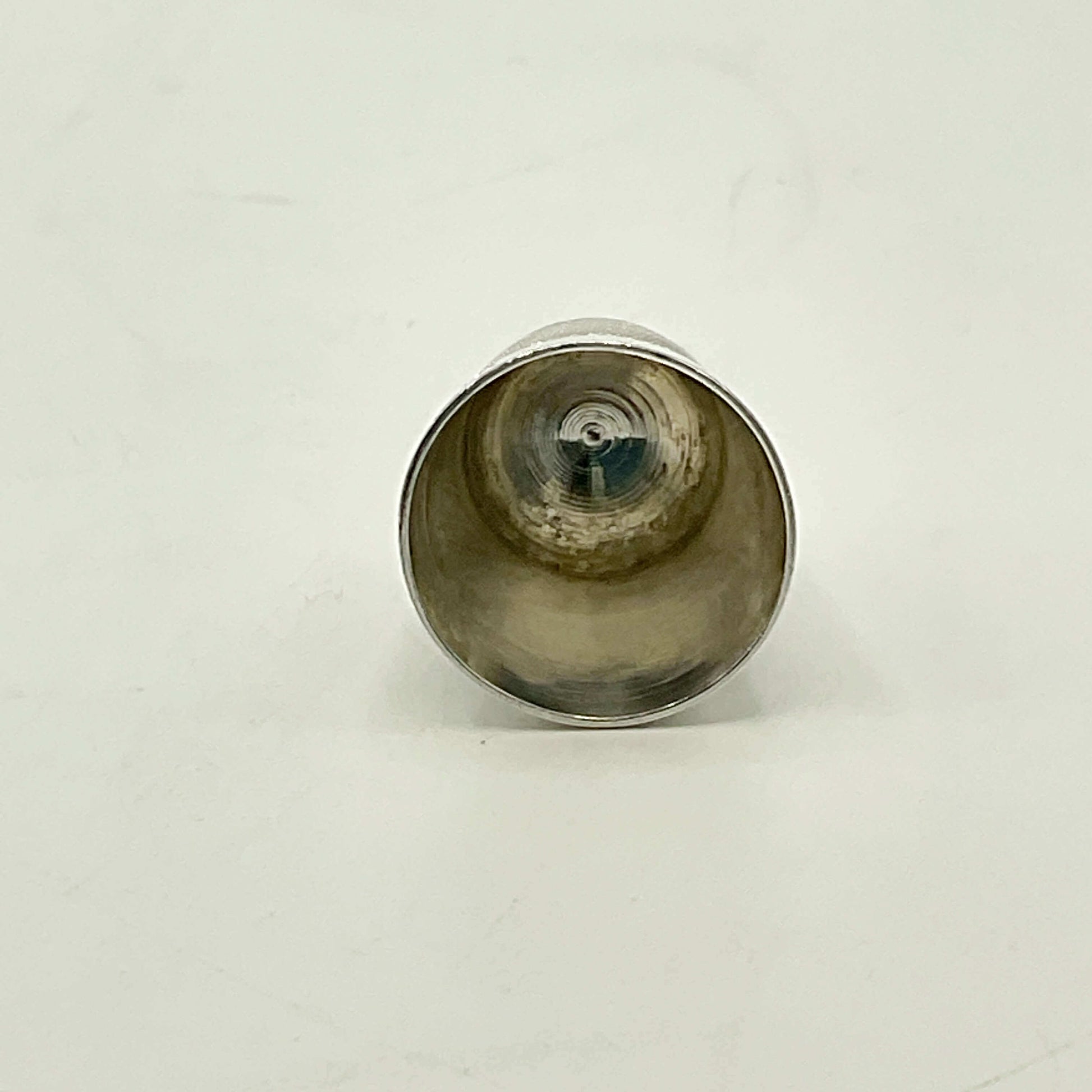 Silver thimble on a white background