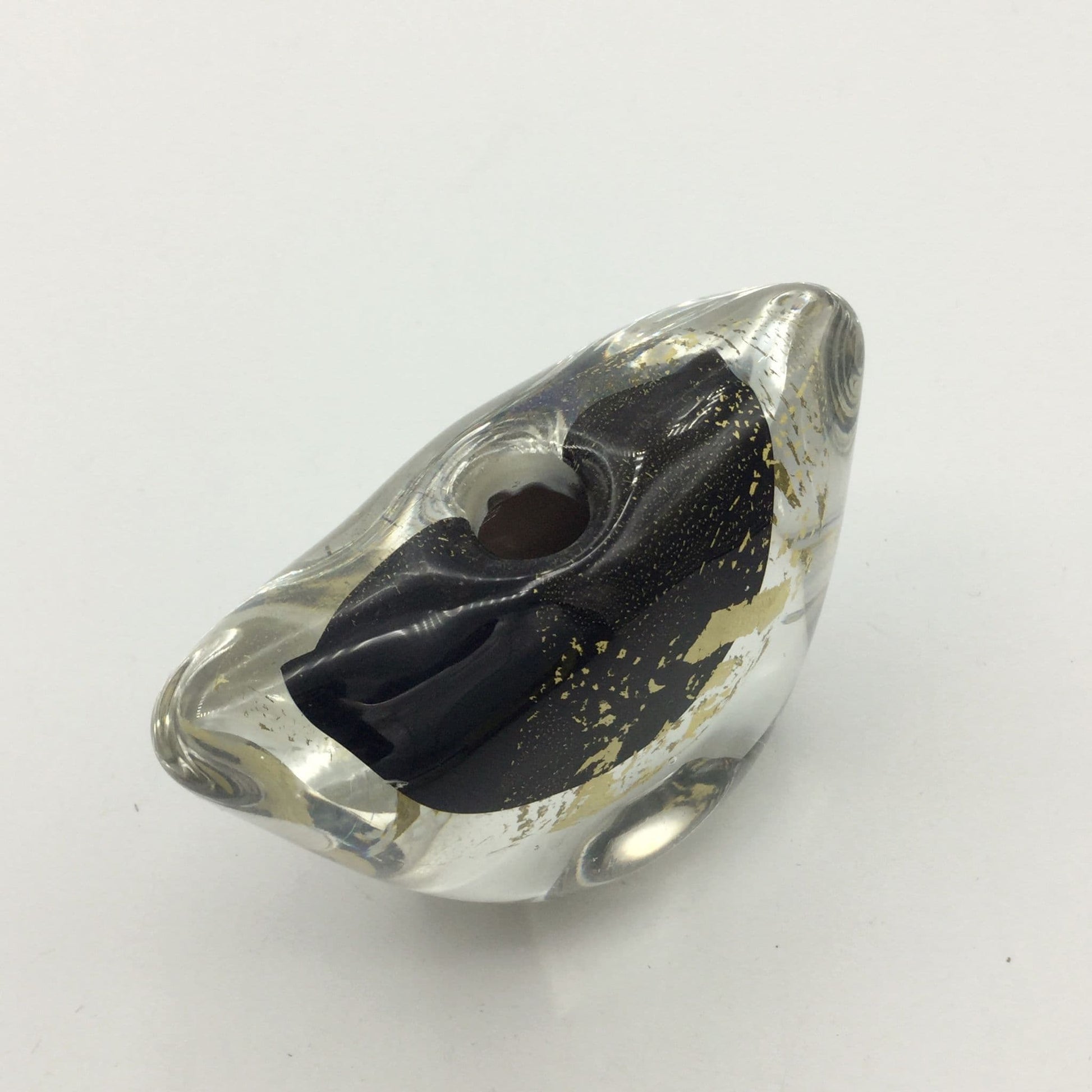 A clear glass art deco style vase with a black interior lining and scattered gold leaf accents, shown on a plain white background.