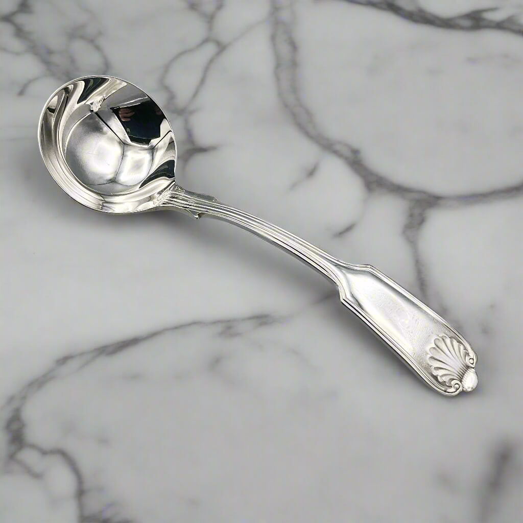 Silver plated ladle on a marble surface