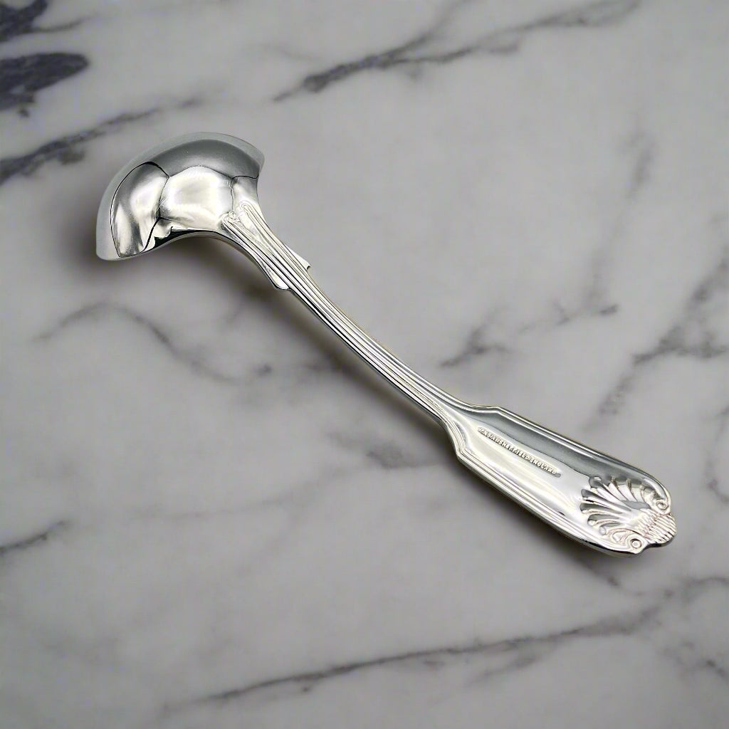 Small Silver Plated Sauce Ladle on a marble worktop