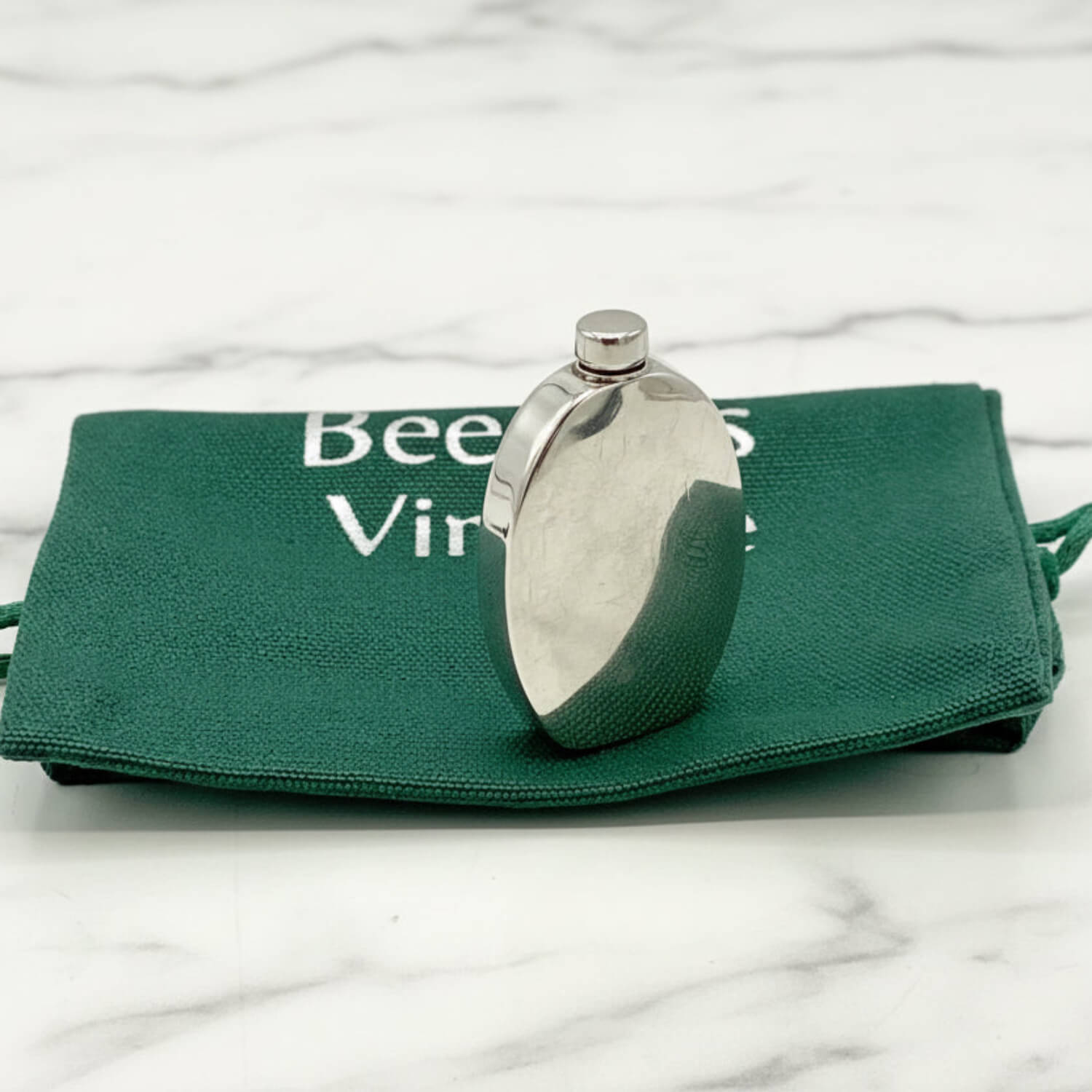 Small Sterling Silver Scent Bottle on a green bag with 'Beeches Vintage' text on a marble surface