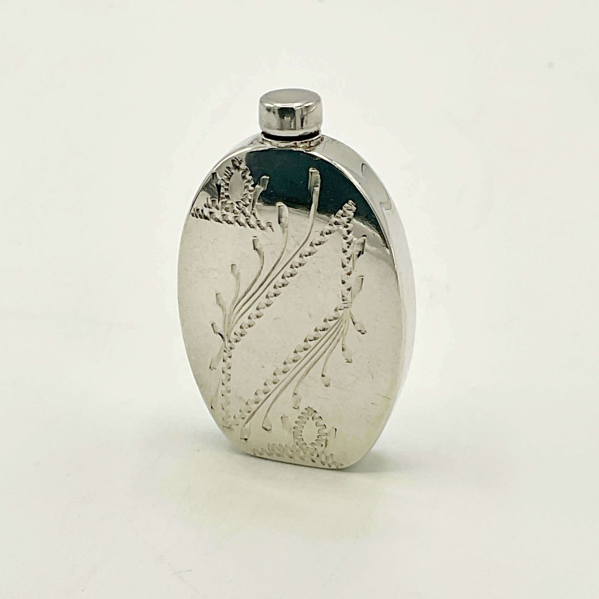 Small Sterling Silver Scent Bottle with engraved design on a white background