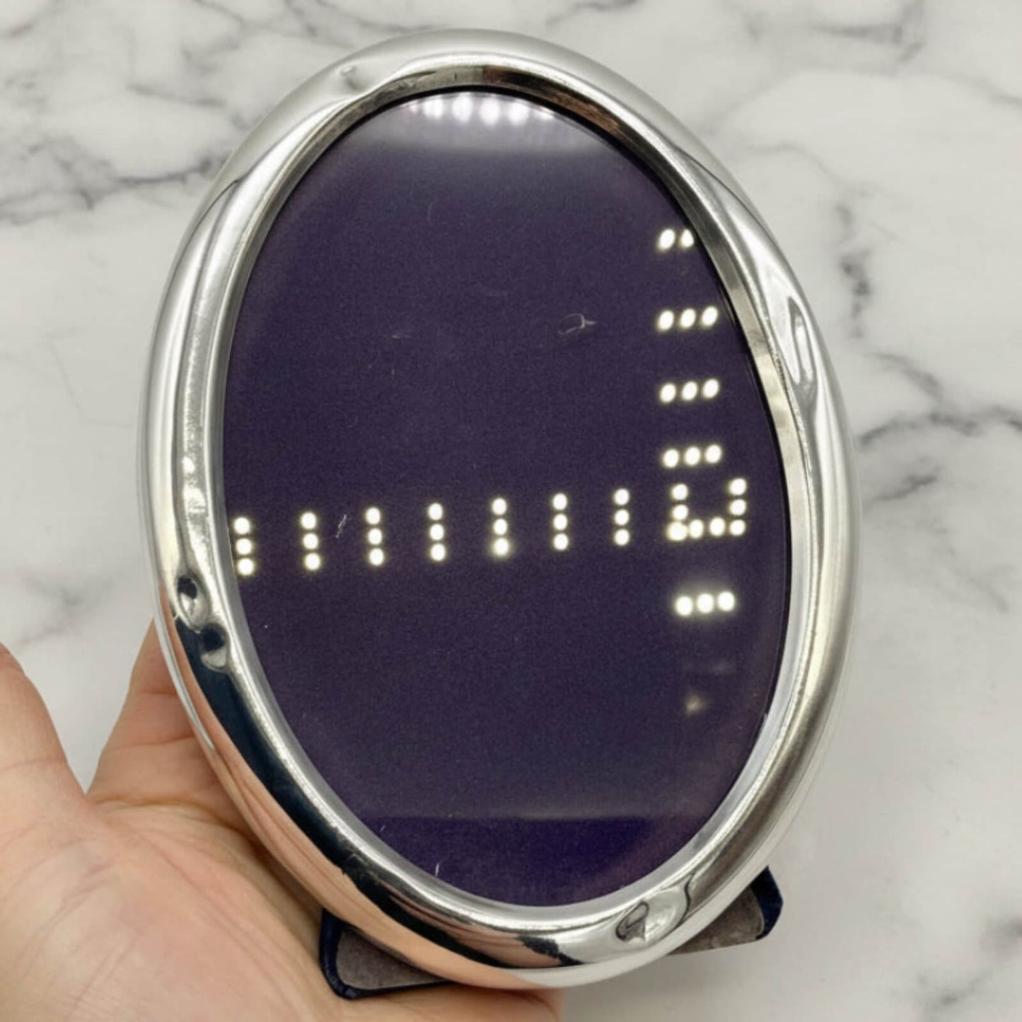 Sterling Silver Oval Photo Frame held in a hand