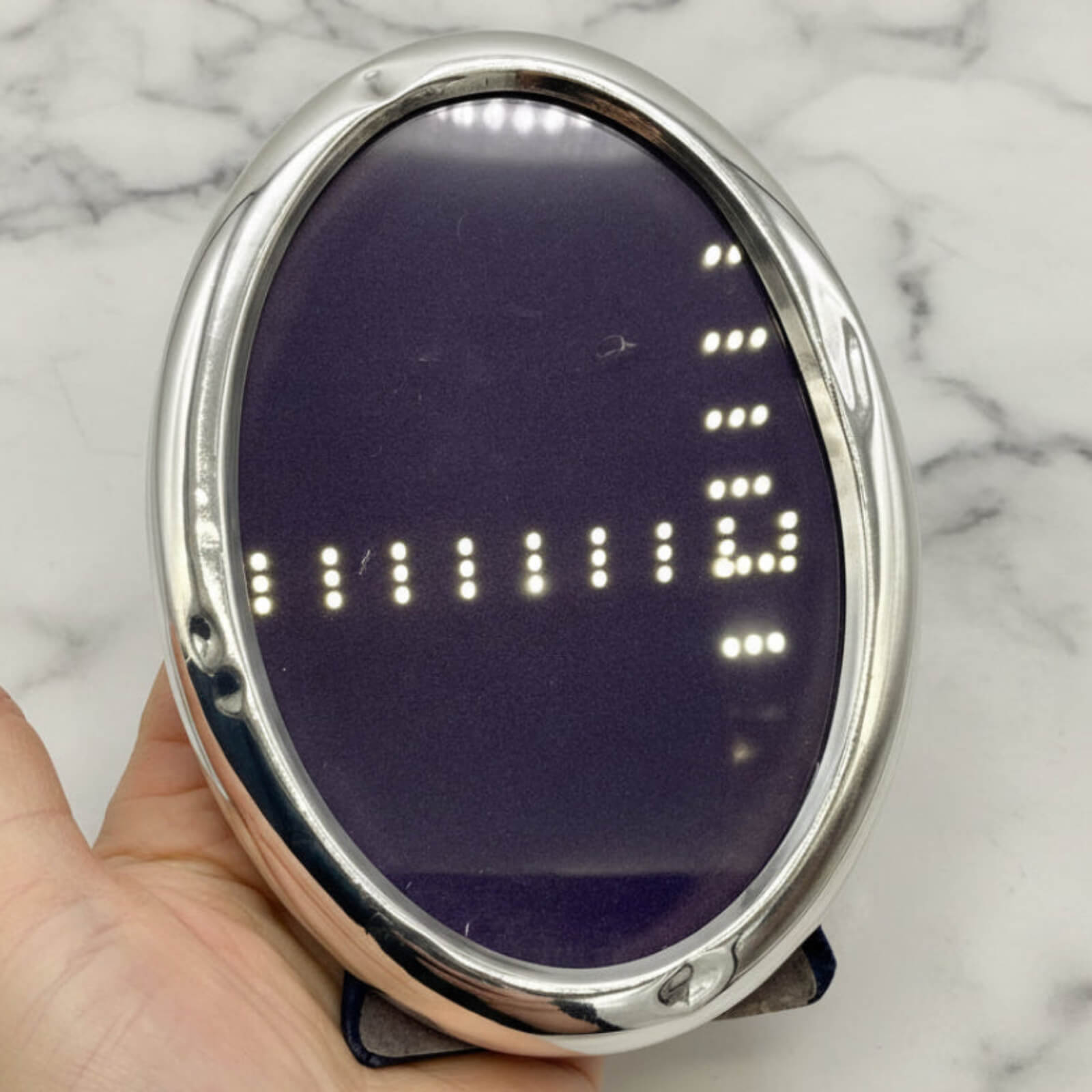 Sterling Silver Oval Photo Frame held in a hand