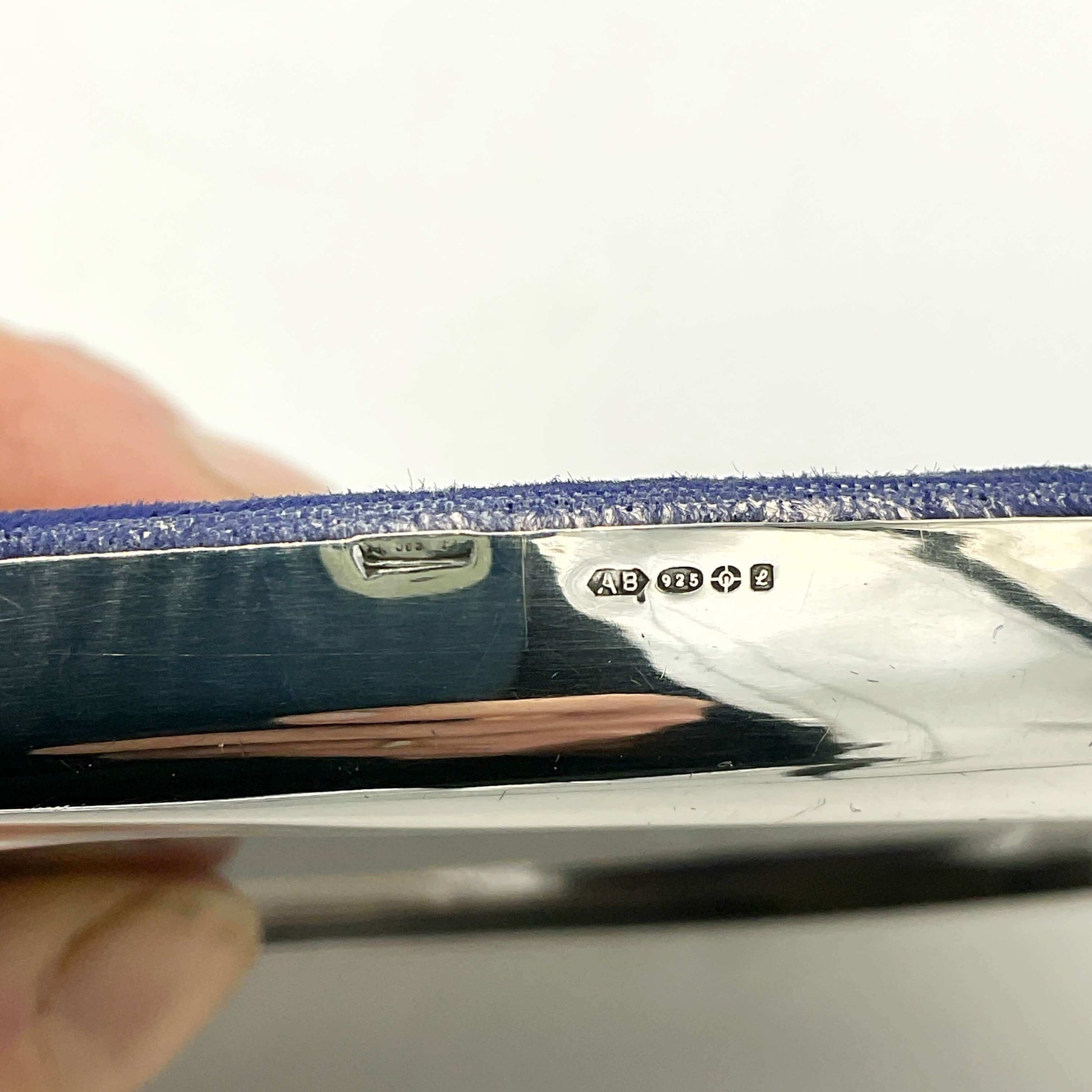Close-up of a silver photo frame with visible hallmarks on a white background