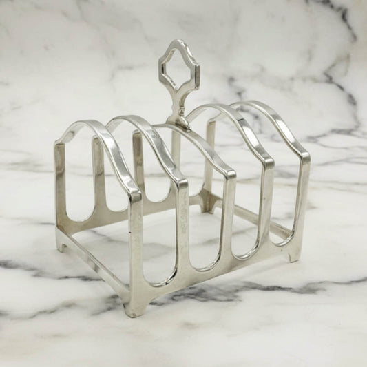 Silver toast rack on a marble surface