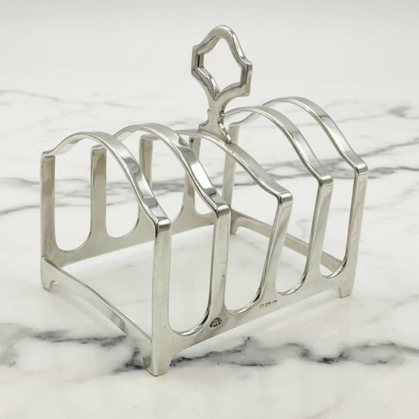 Silver toast rack on a marble surface