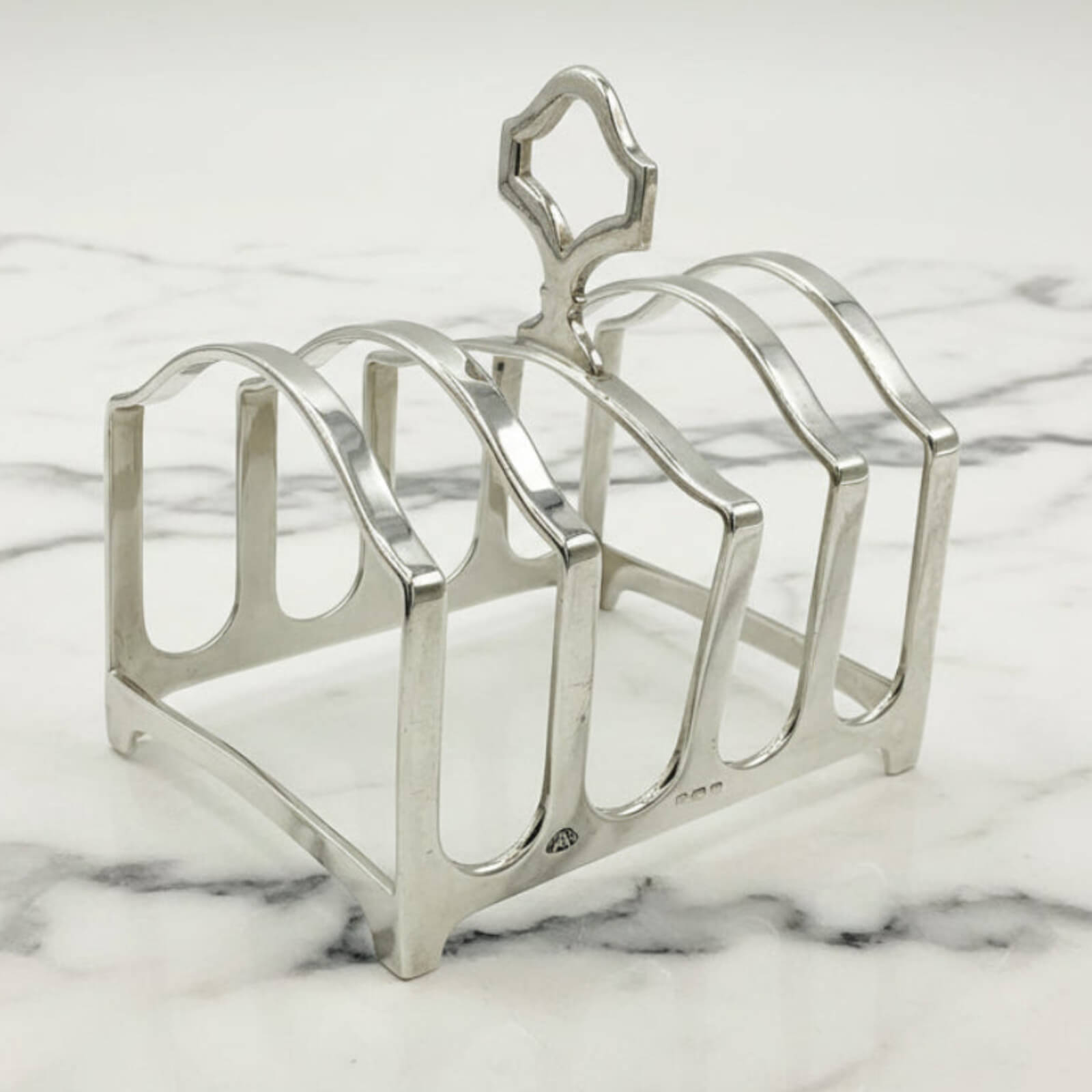 Silver toast rack on a marble surface