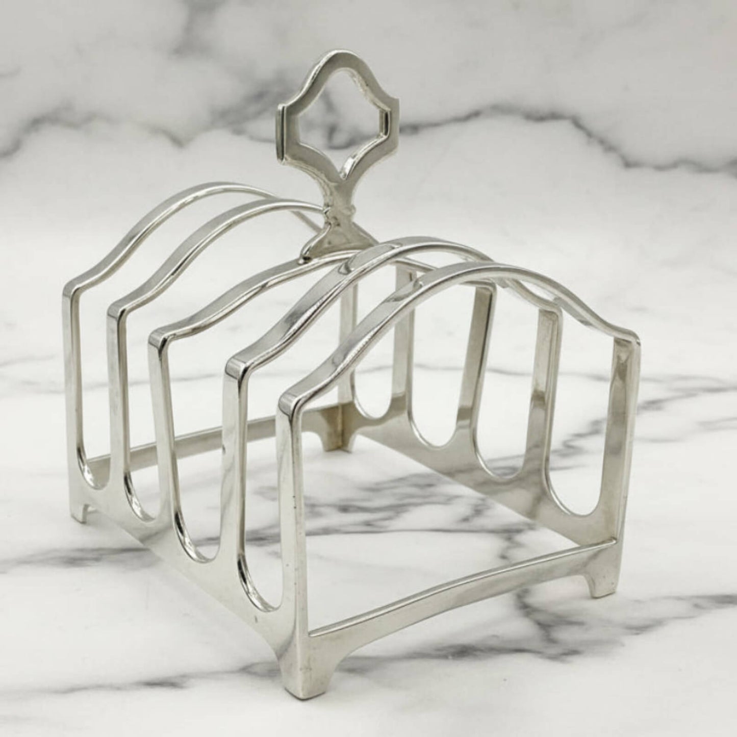 Silver toast rack on a marble surface