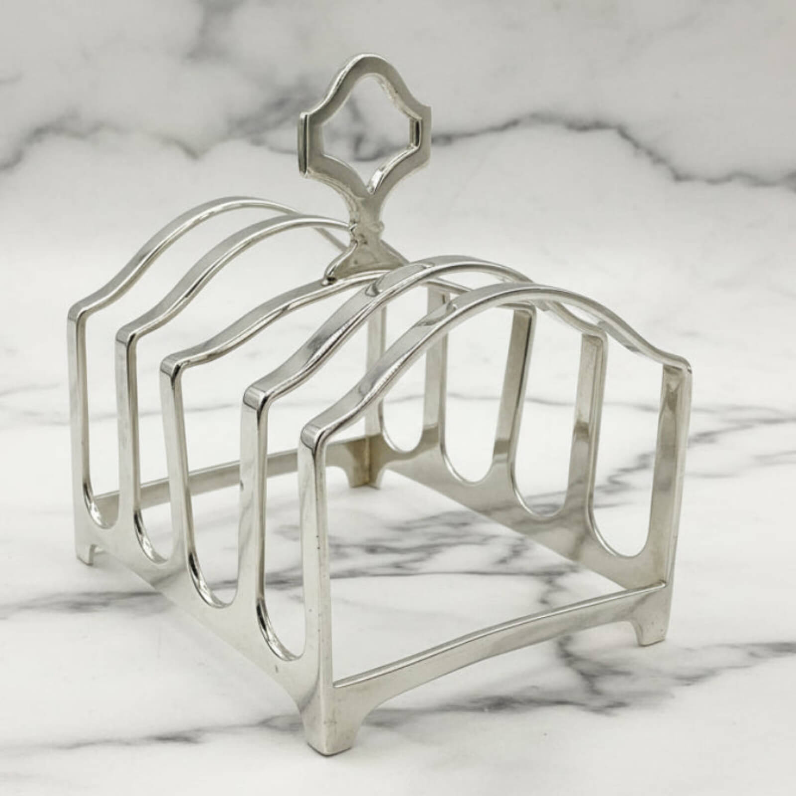 Silver toast rack on a marble surface