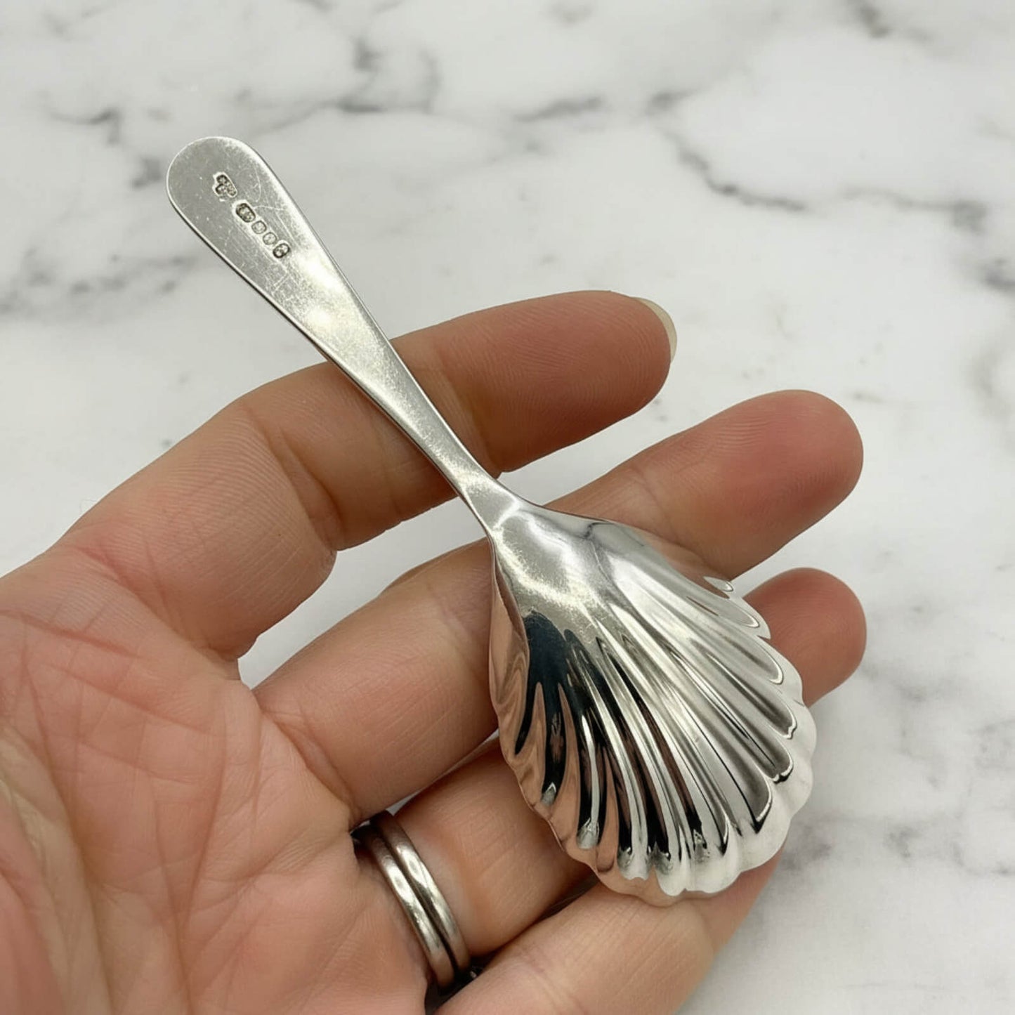 Vintage 1977 Sterling Silver Tea Caddy Spoon held in a hand