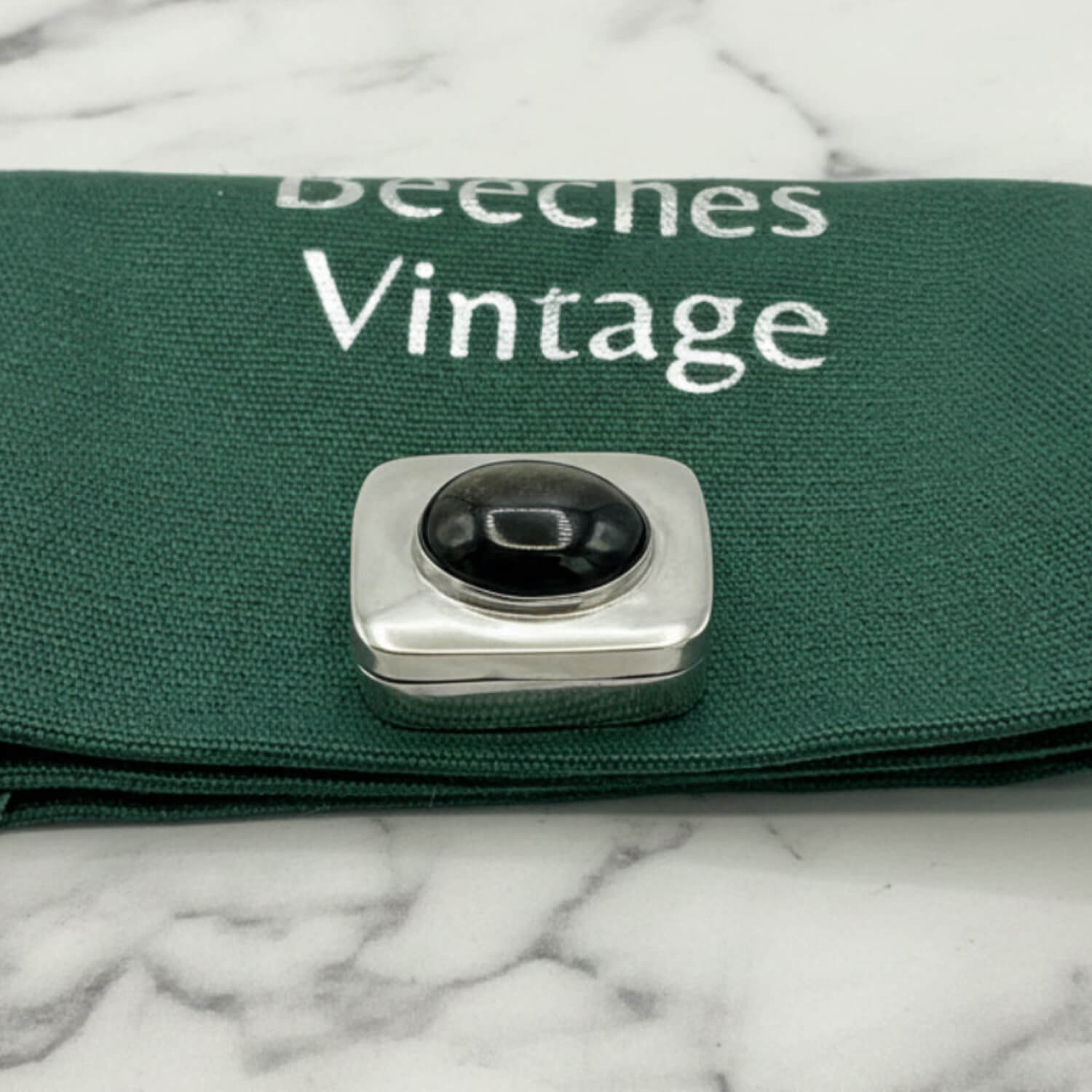 Vintage Black Gemstone Silver Pill Box on green bag