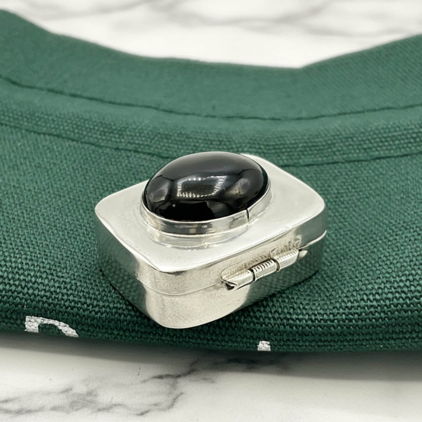 Vintage Black Gemstone Silver Pill Box on green bag 