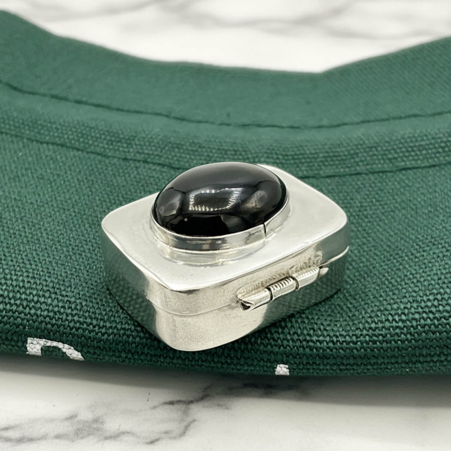 Vintage Black Gemstone Silver Pill Box on green bag 