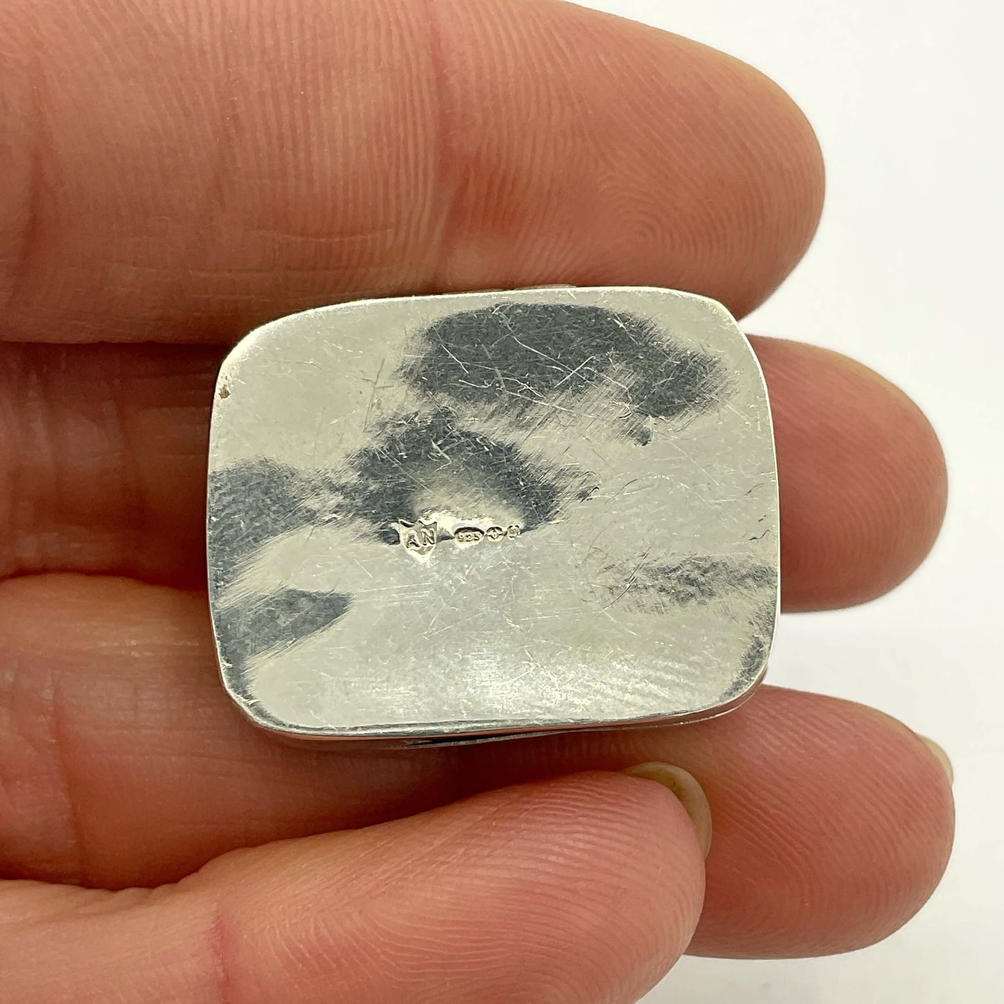 base of Vintage Black Gemstone Silver Pill Box with hallmarks in hand