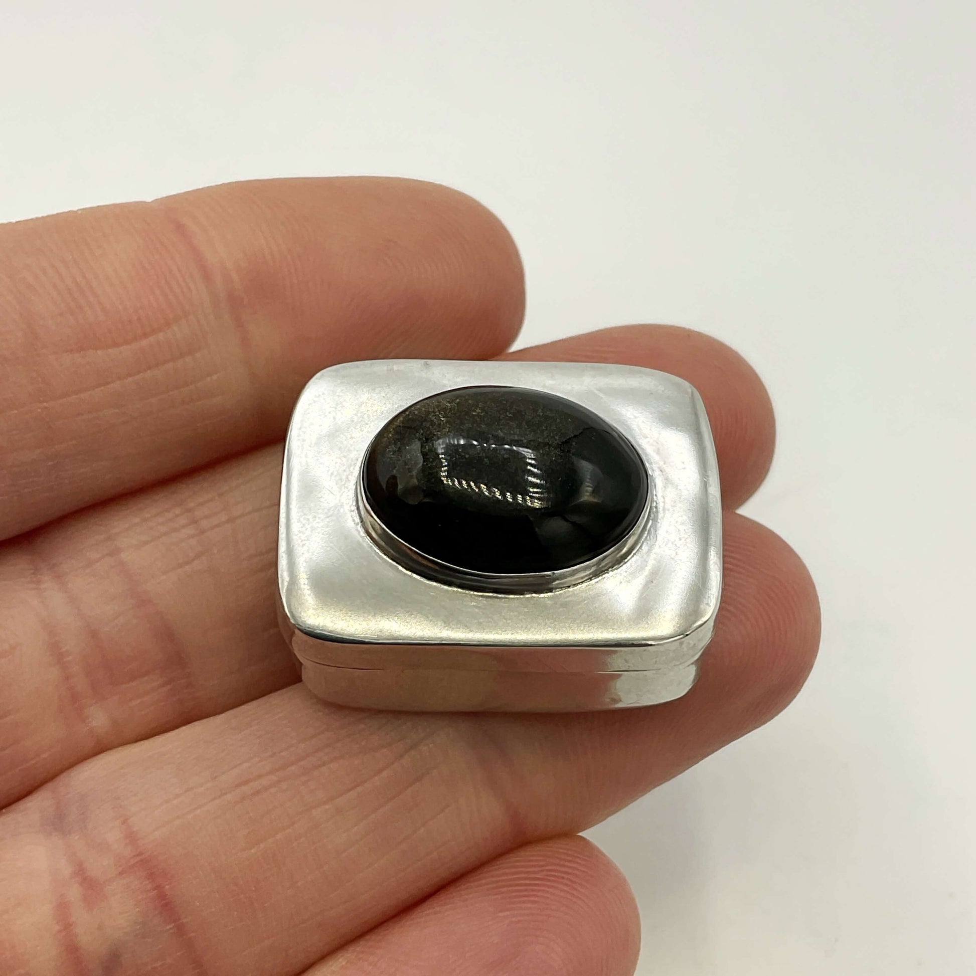Vintage Black Gemstone Silver Pill Box held in a hand