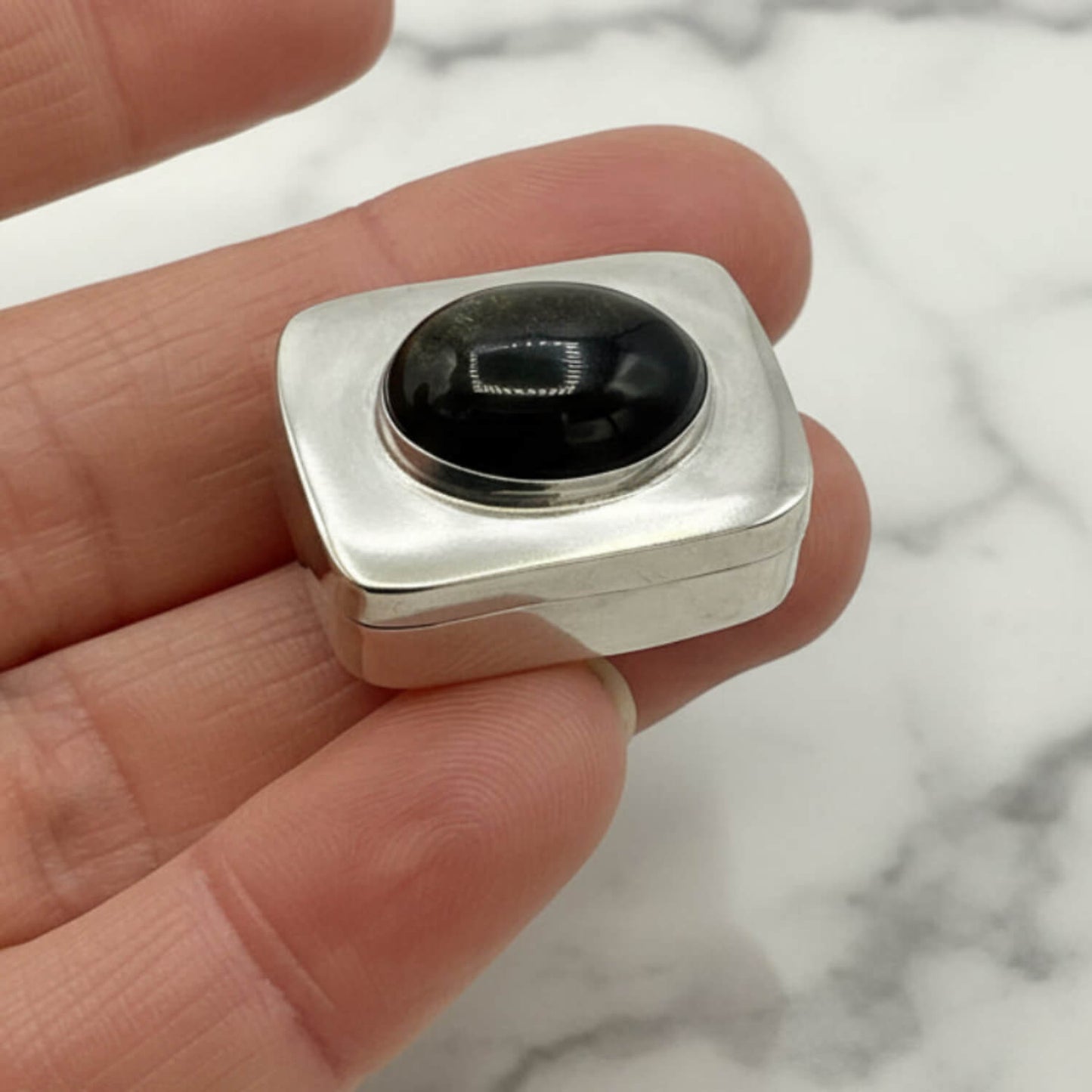 Vintage Black Gemstone Silver Pill Box held in a hand