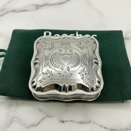 Vintage Small Dutch Silver Box On a green bag on a marble surface 