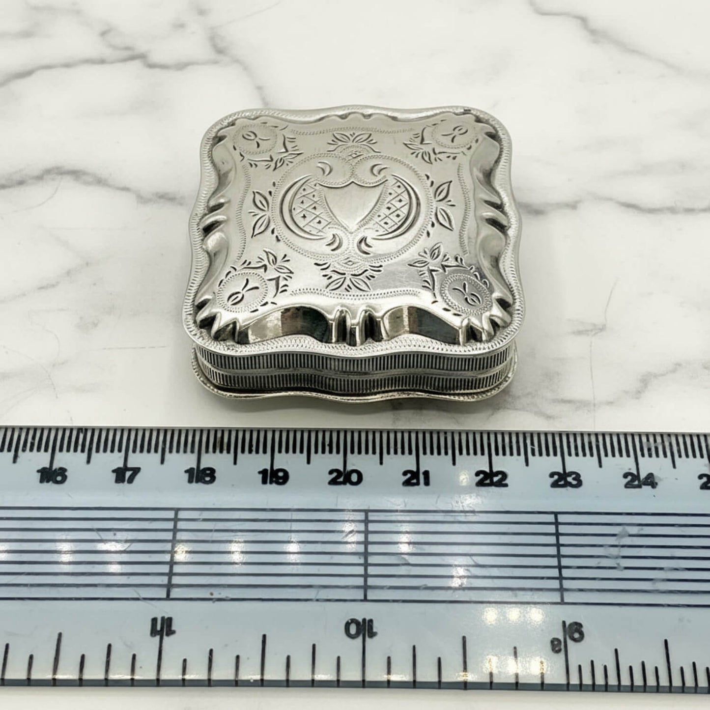 Vintage Small Dutch Silver Box Next to a ruler for scale on a marble worktop