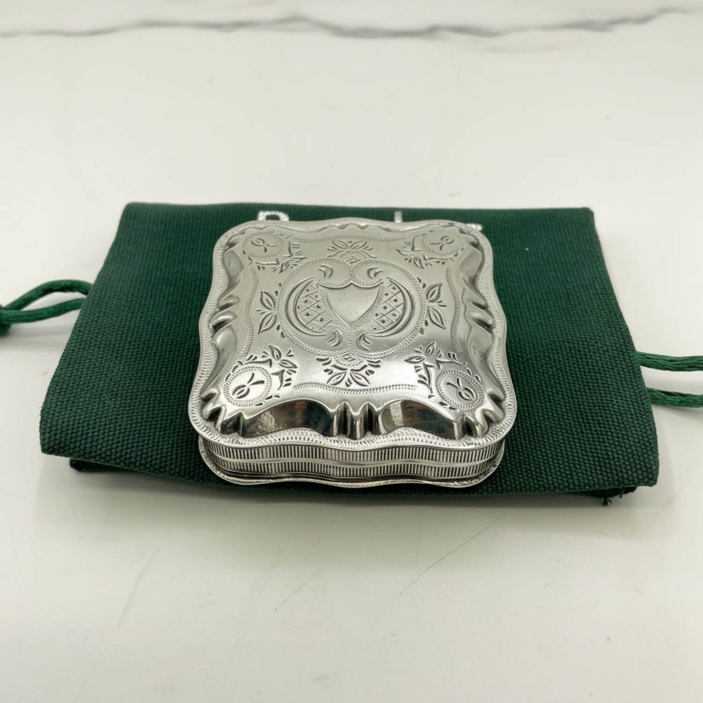 Vintage Small Dutch Silver Box On a green bag and marble surface 