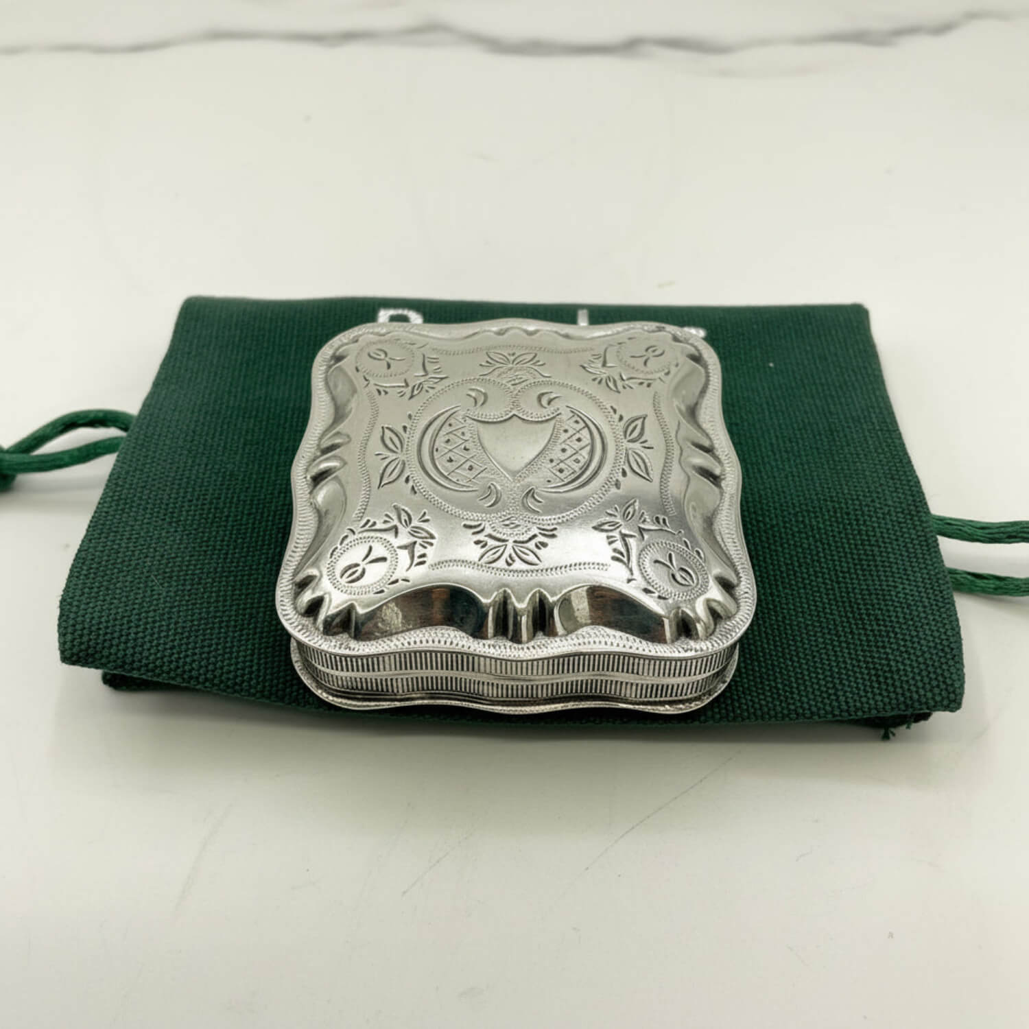 Vintage Small Dutch Silver Box On a green bag and marble surface 