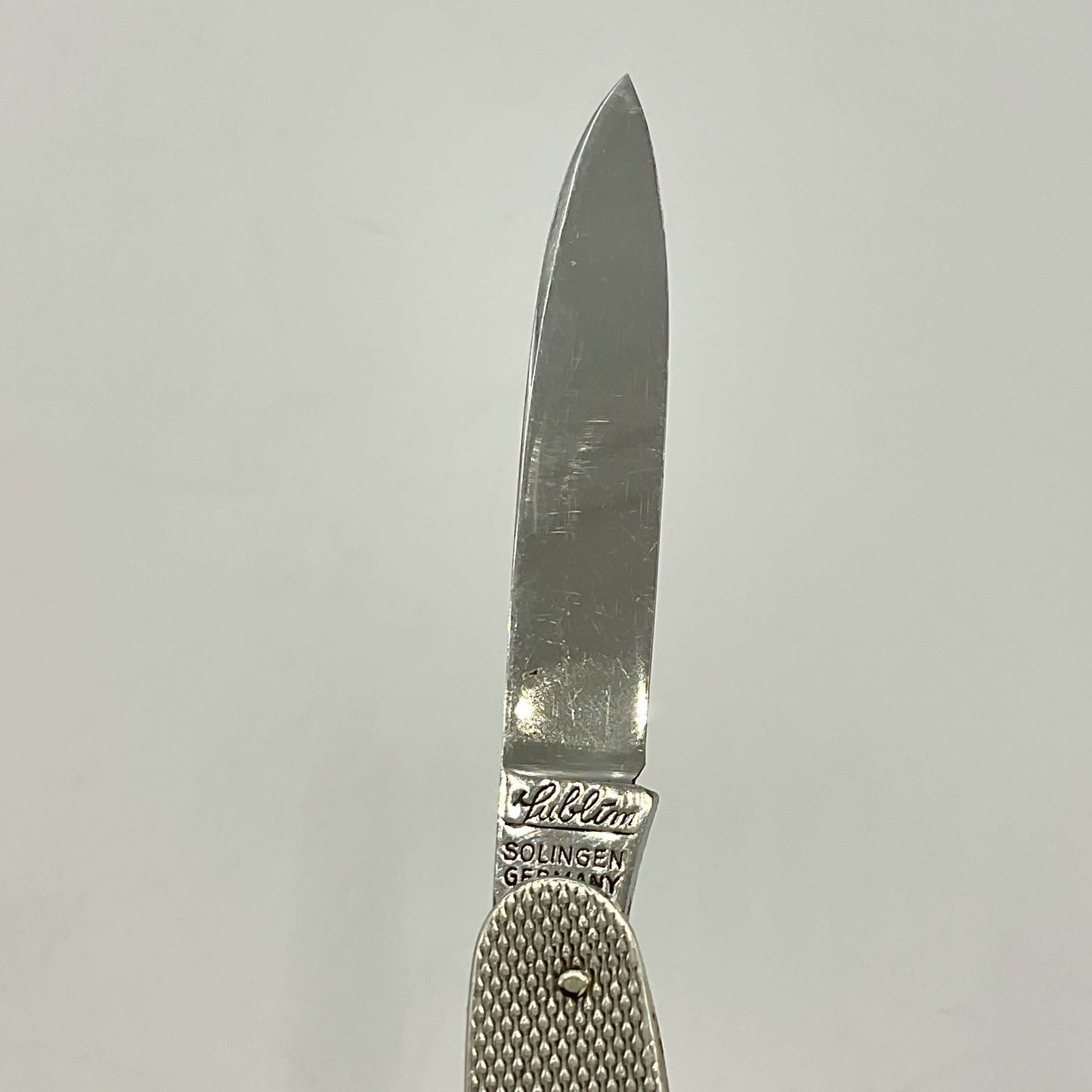 Knife blade with 'Lublim' branding on a light gray background