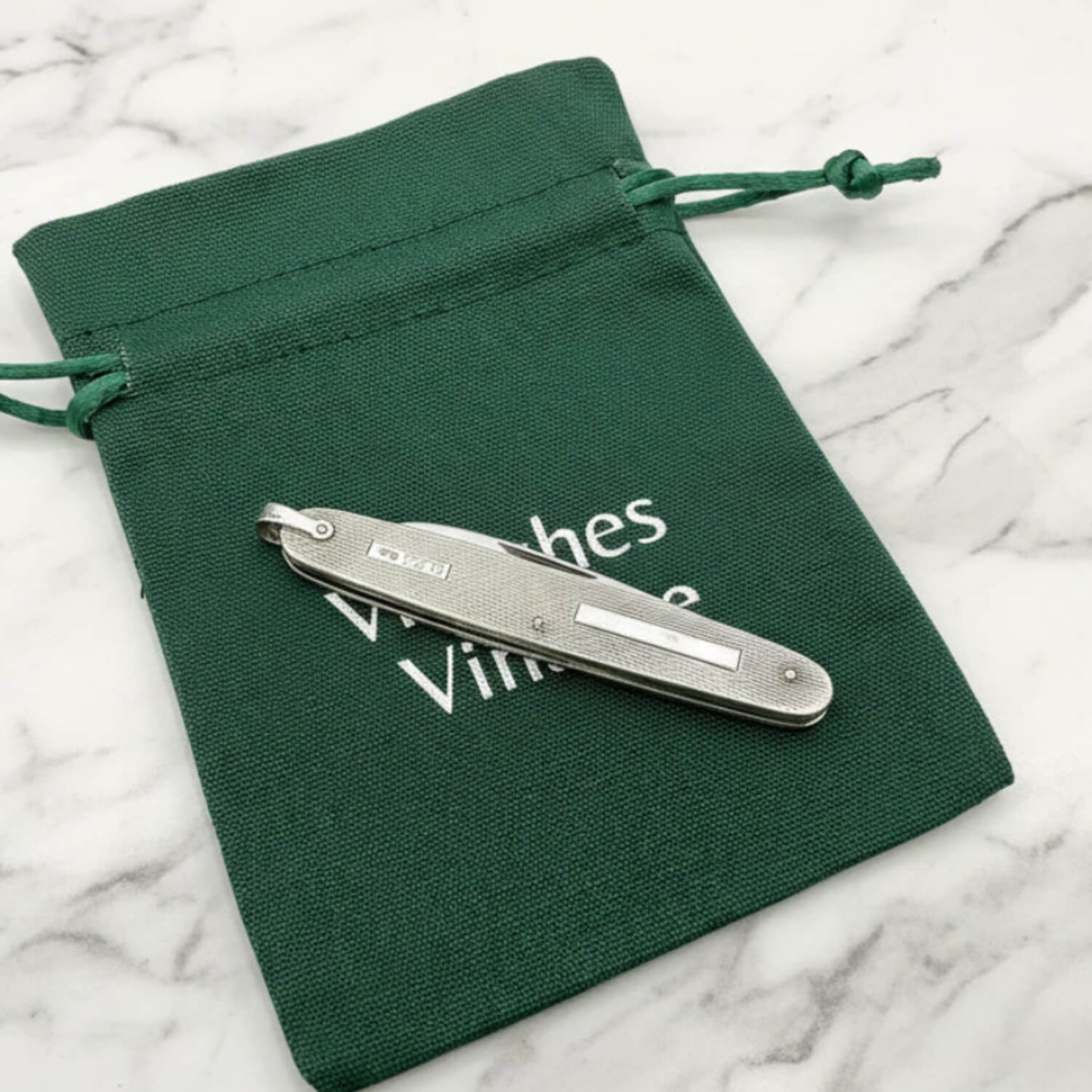 Vintage Sterling Silver Pen Knife on a green bag and marble worktop
