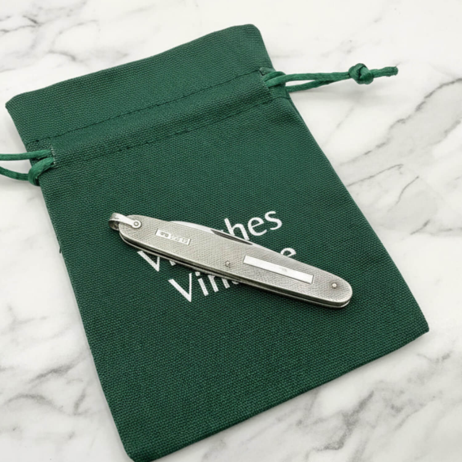 Vintage Sterling Silver Pen Knife on a green bag and marble worktop
