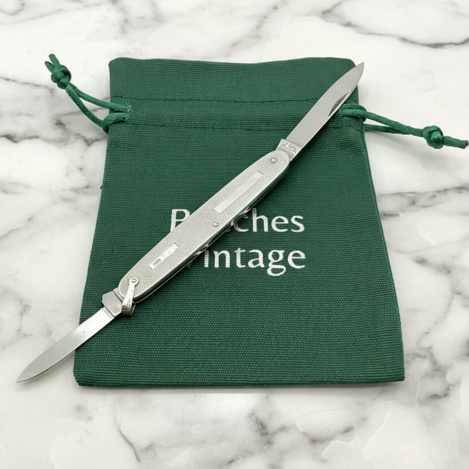 Vintage Sterling Silver Pen Knife on a green gift bag and marble surface