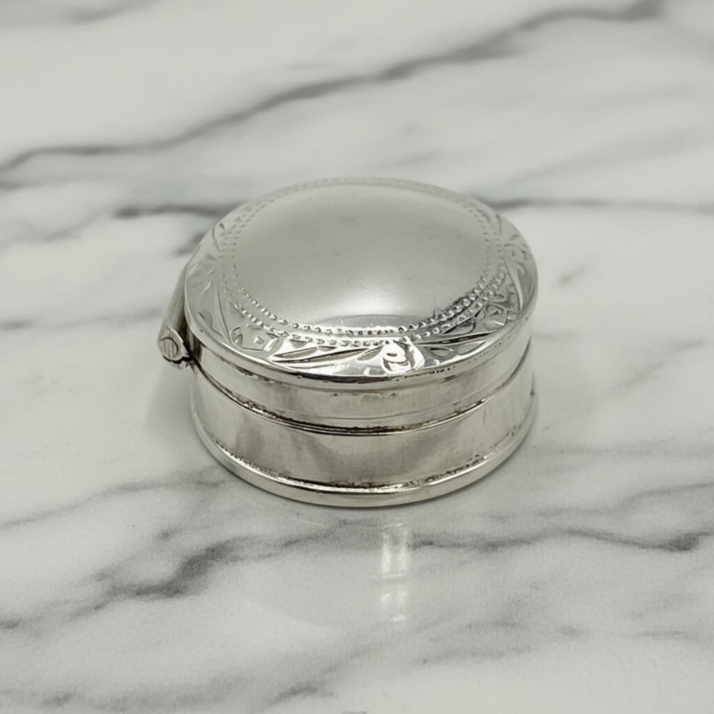Vintage Sterling Silver Pill Box on a marble surface