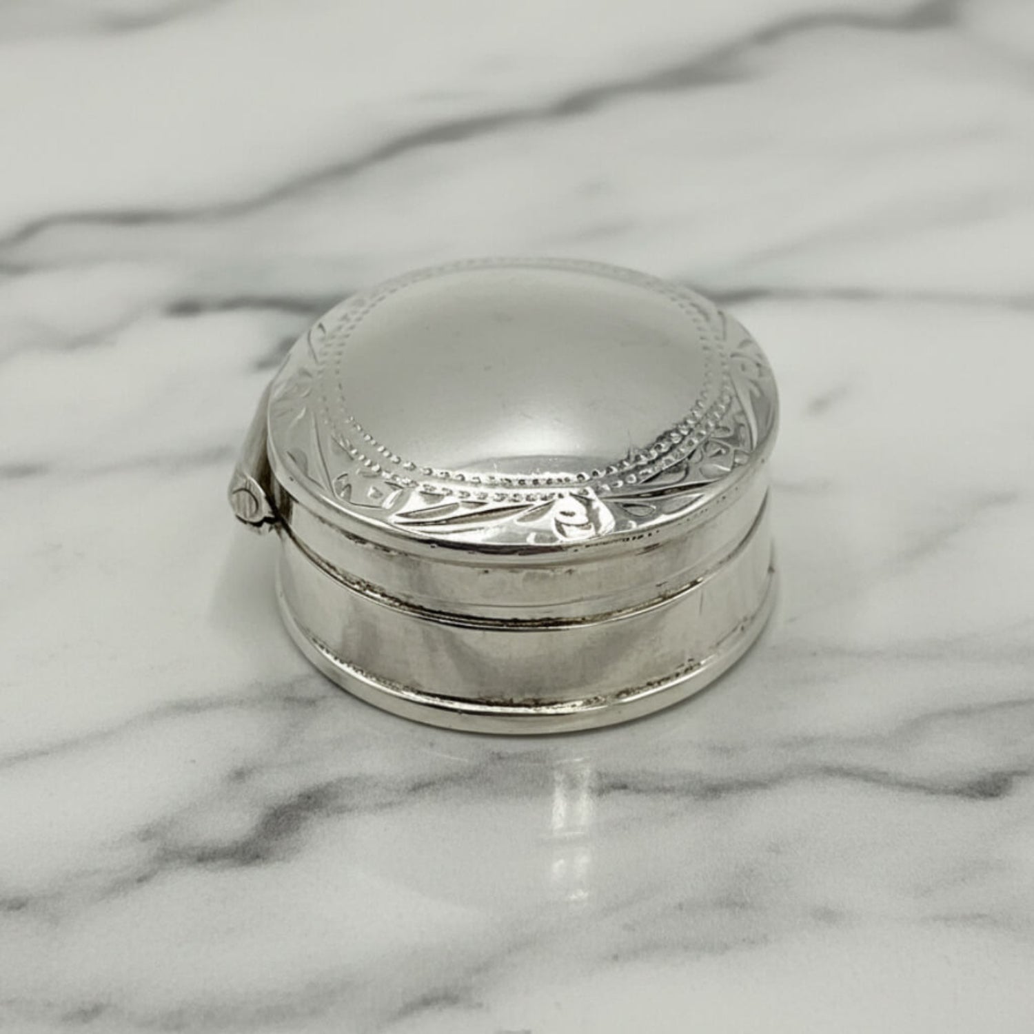 Vintage Sterling Silver Pill Box on a marble surface