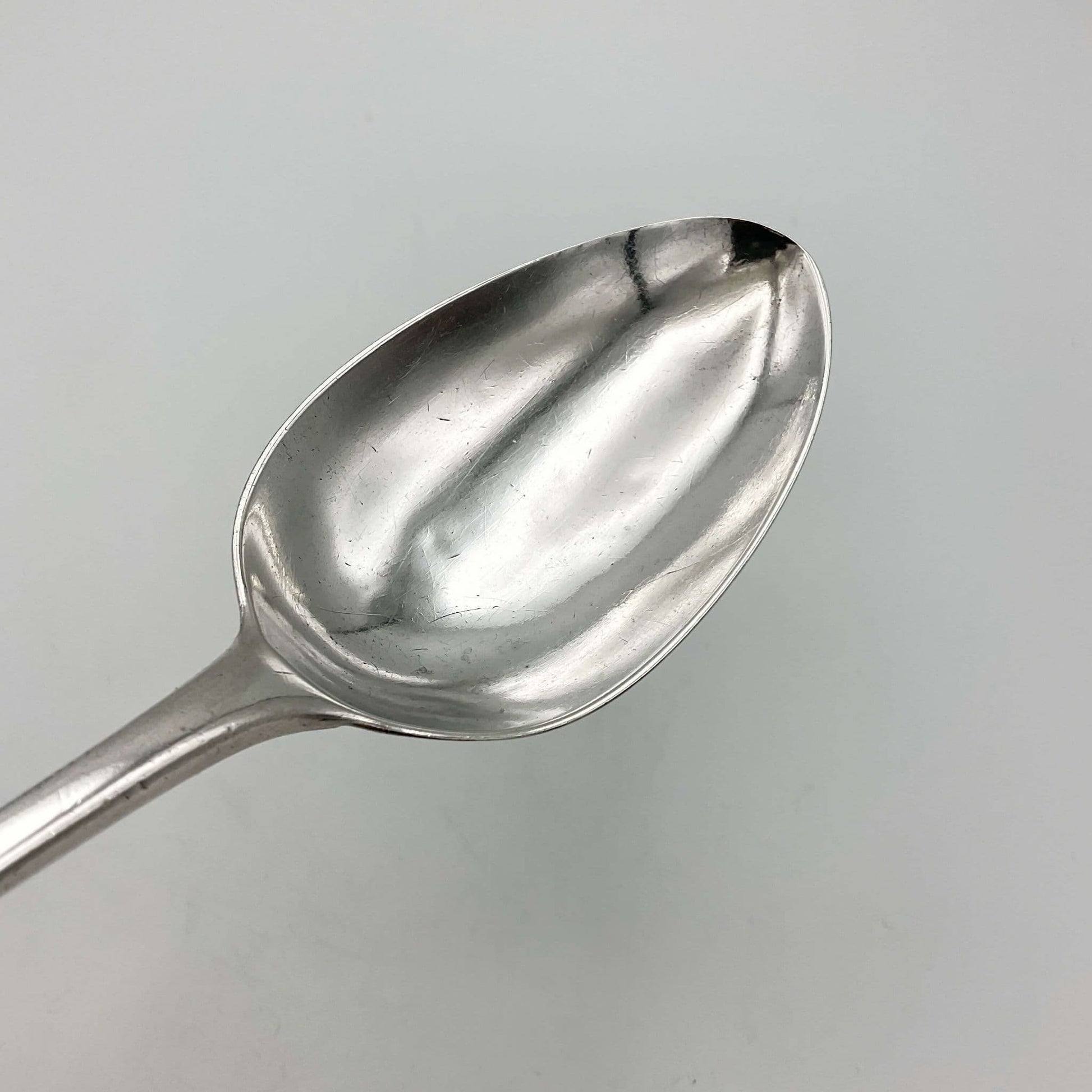 lovely silver bowl of serving spoon on white background