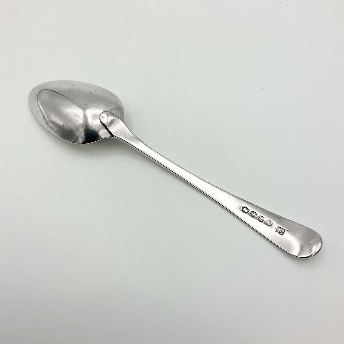 back view of Antique Georgian Sterlnig Silver Dessert Spoon on a white background