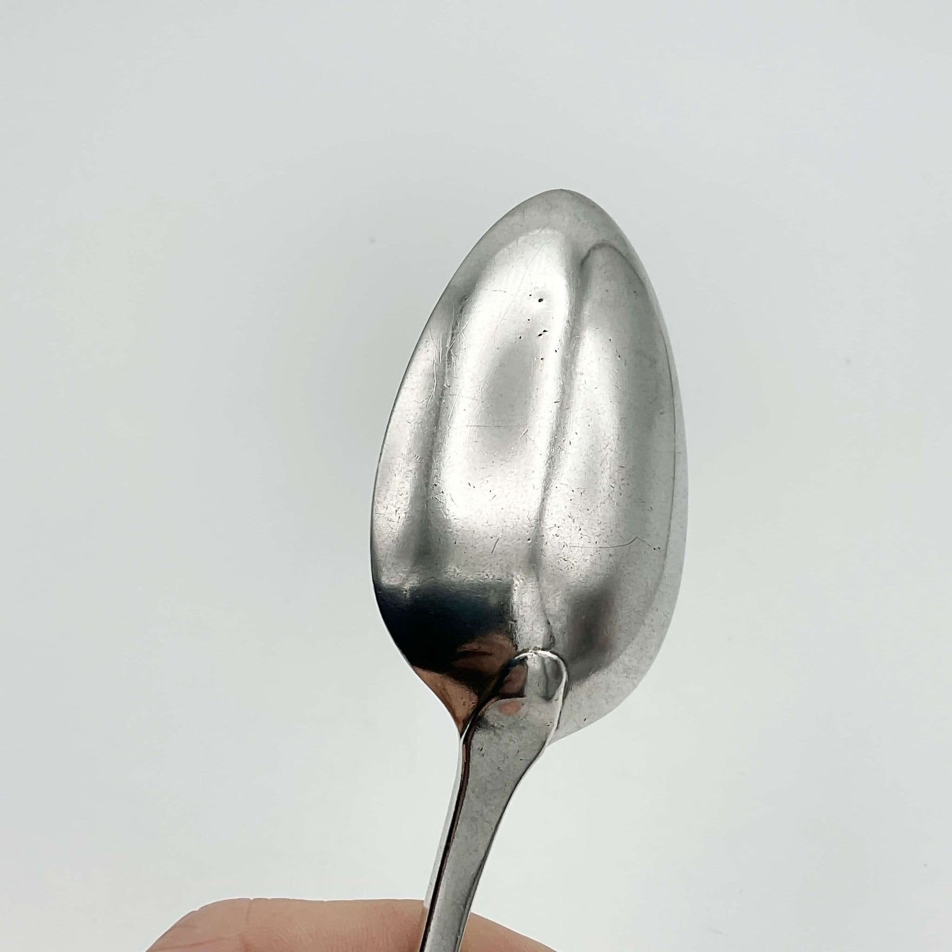 back view of bowl of antique silver dessert spoon