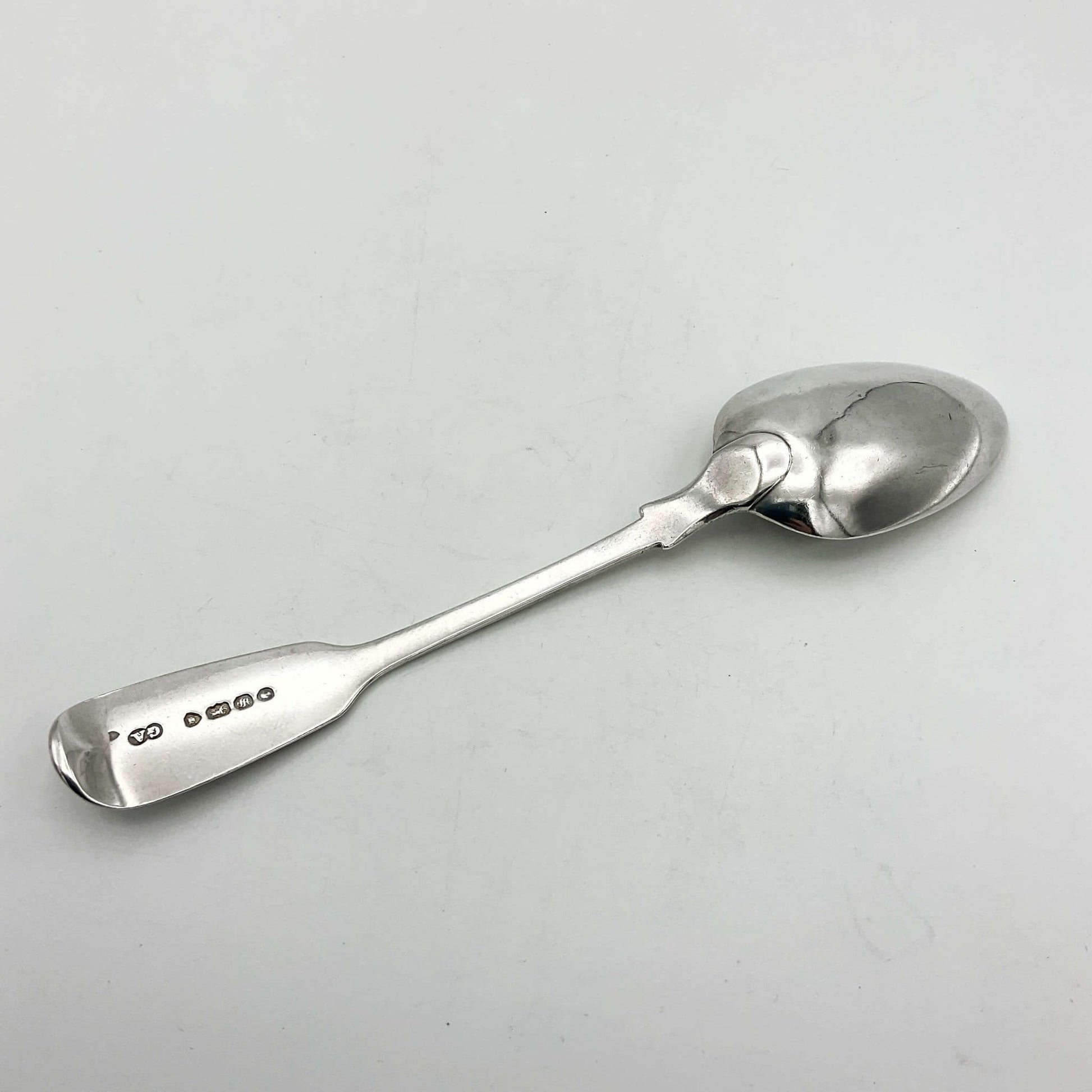 Back of Antique silver teaspoon on a white background