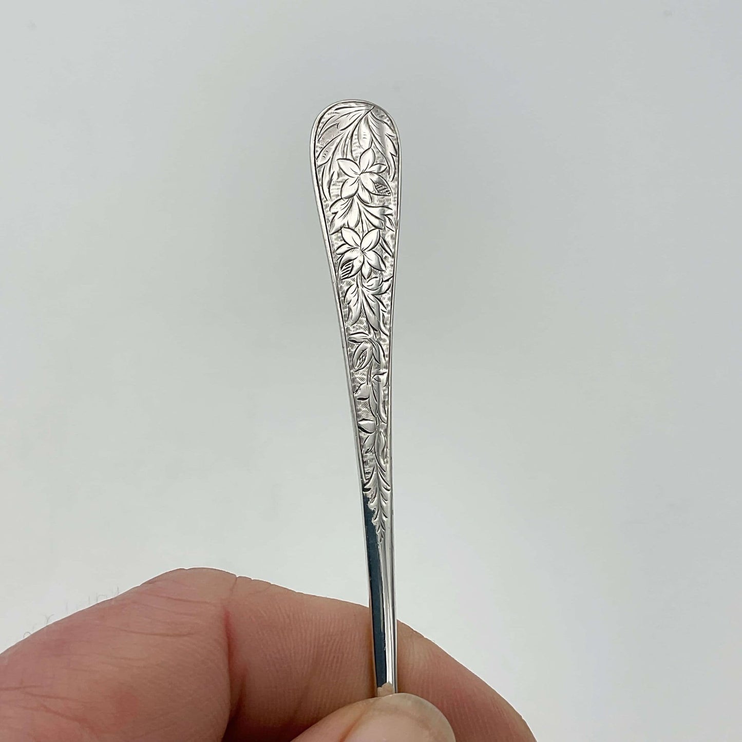 Beautiful engraved flower pattern on handle of spoon