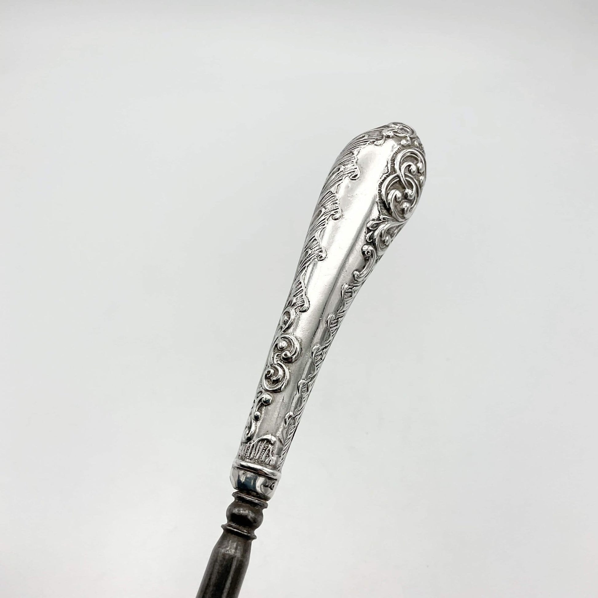 beautiful detailing on silver handle featuring scrolls on button hook