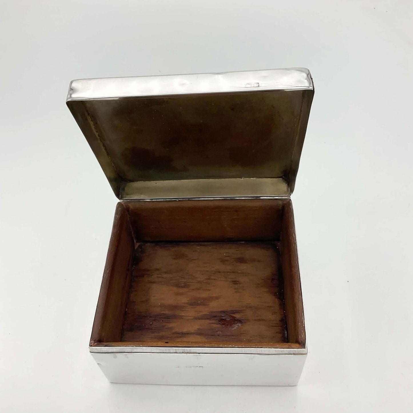Antique Silver Cigarette Box from 1900s with the lid open showing a wooden interior base