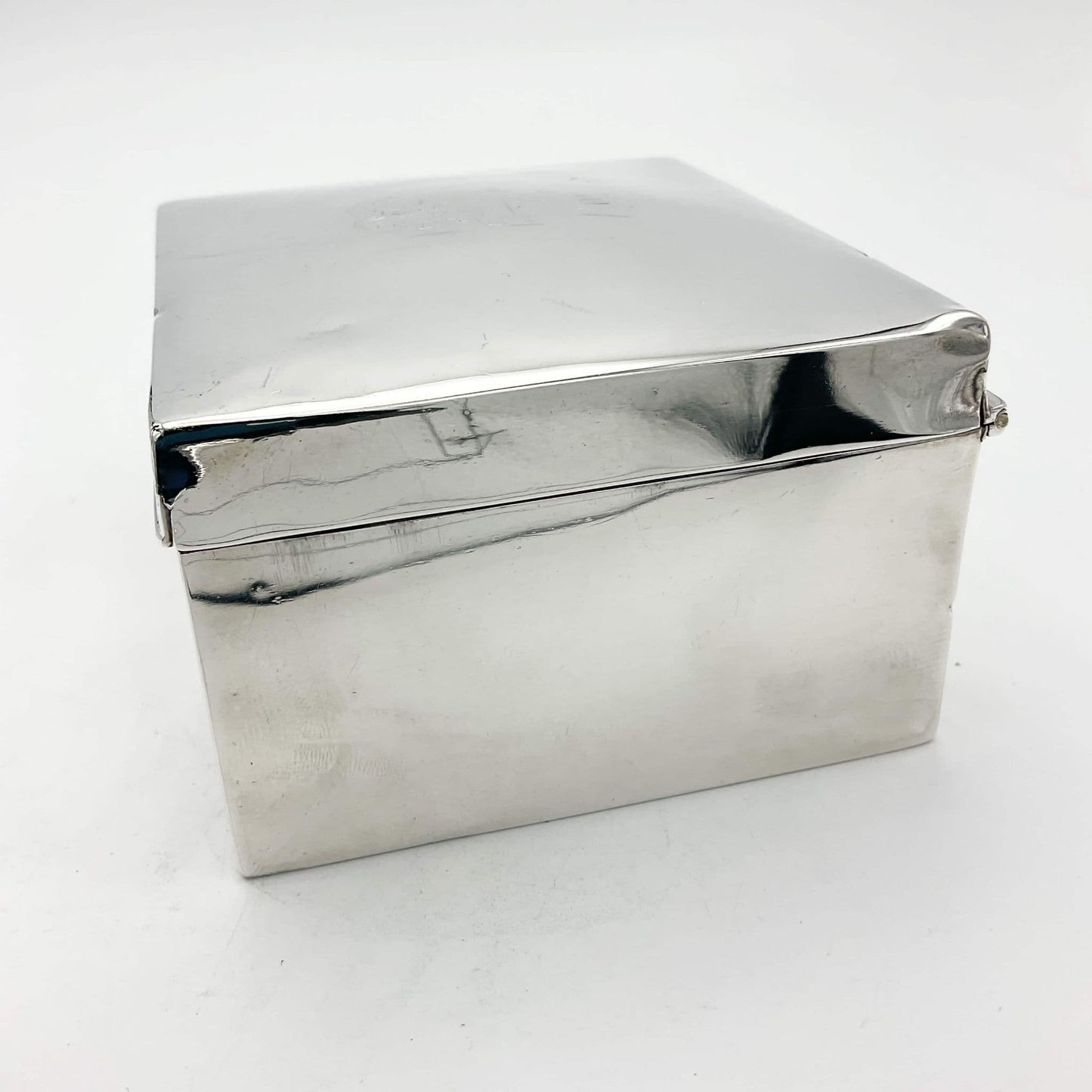 Side view of Antique 1900 silver cigarette box a white background