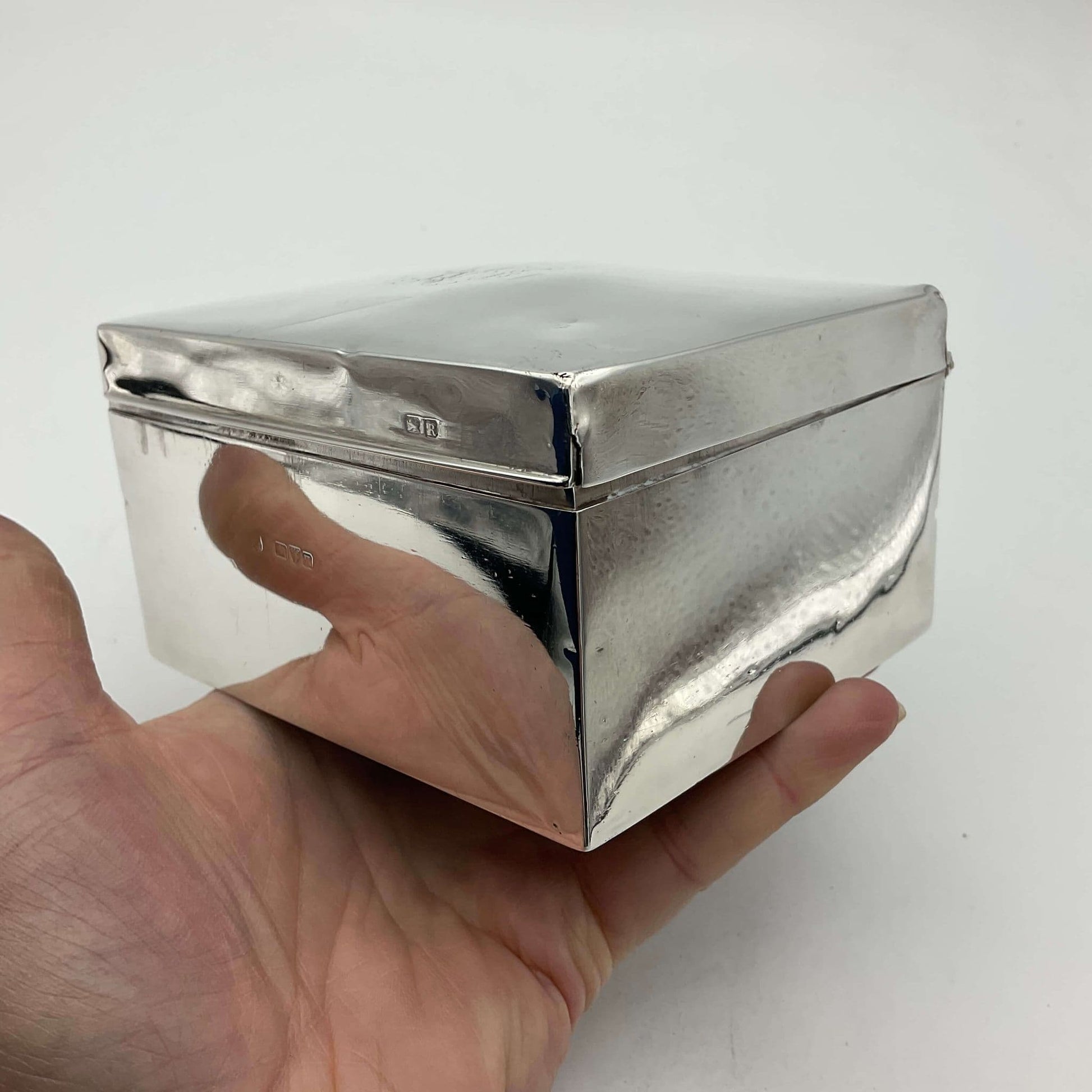 Antique Solid Silver Cigarette Box he’d in a hand showing how reflective the silver is