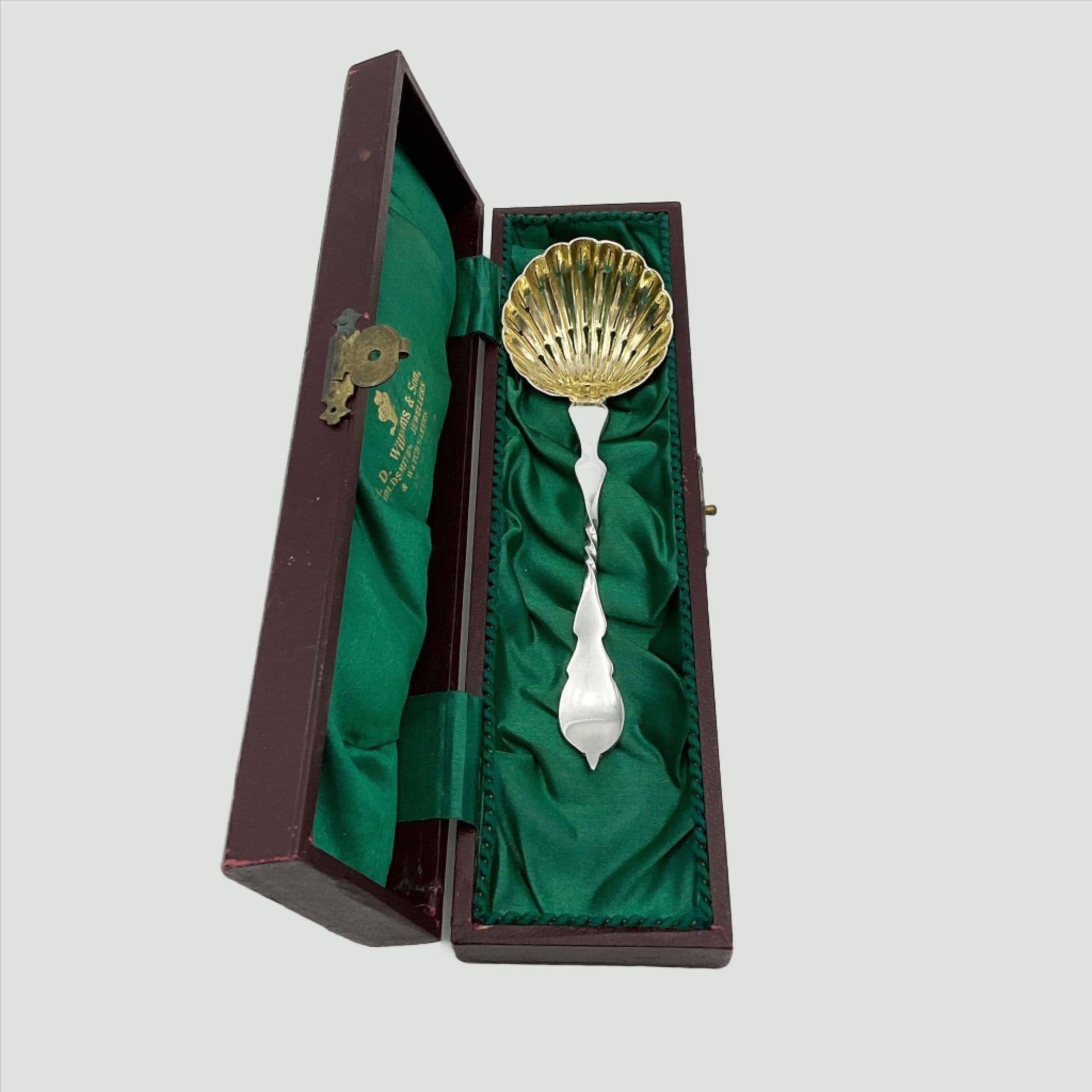 Beautiful gilded Silver sugar sifter spoon in a green lined presentation box