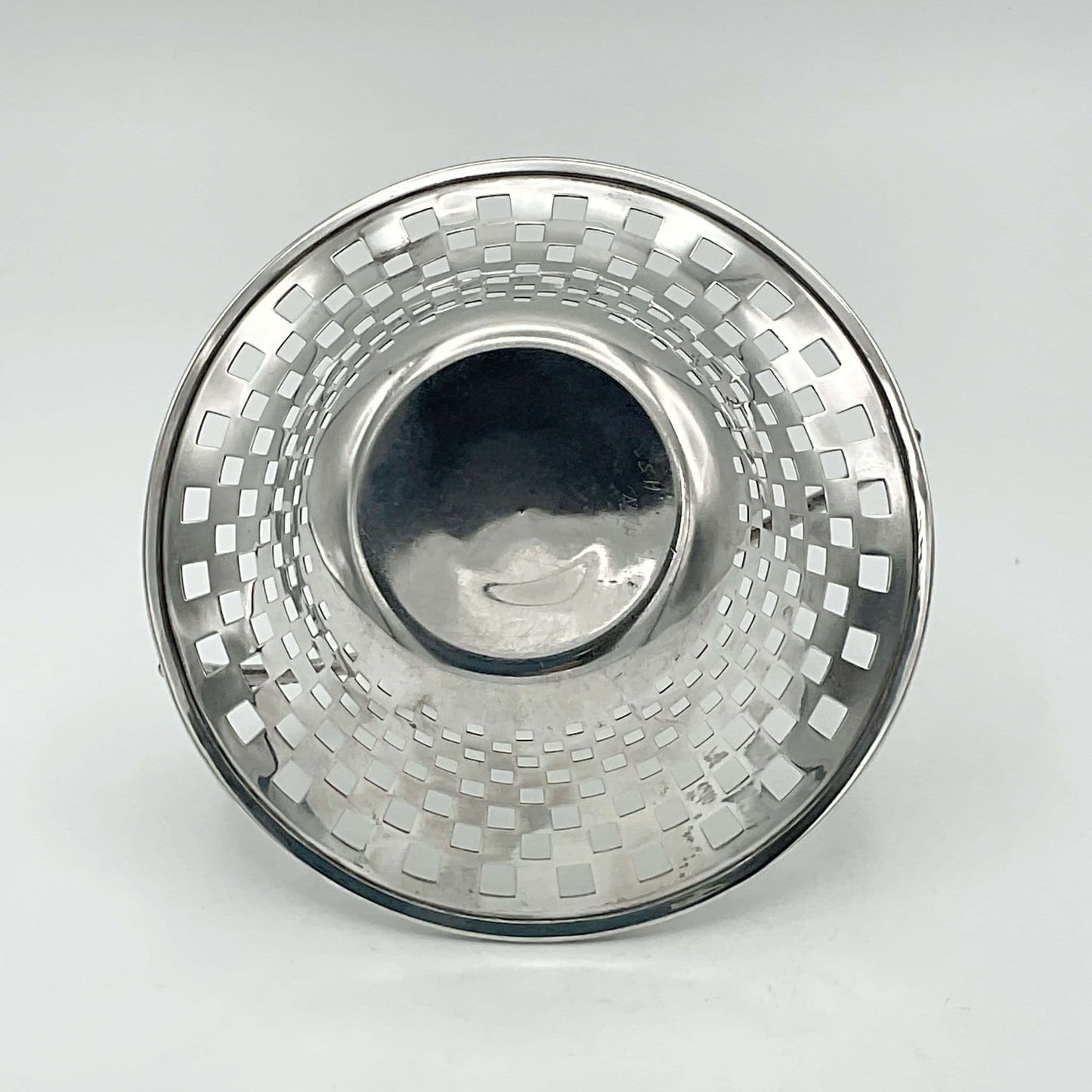 Base of silver basket showing pierced patterned sides